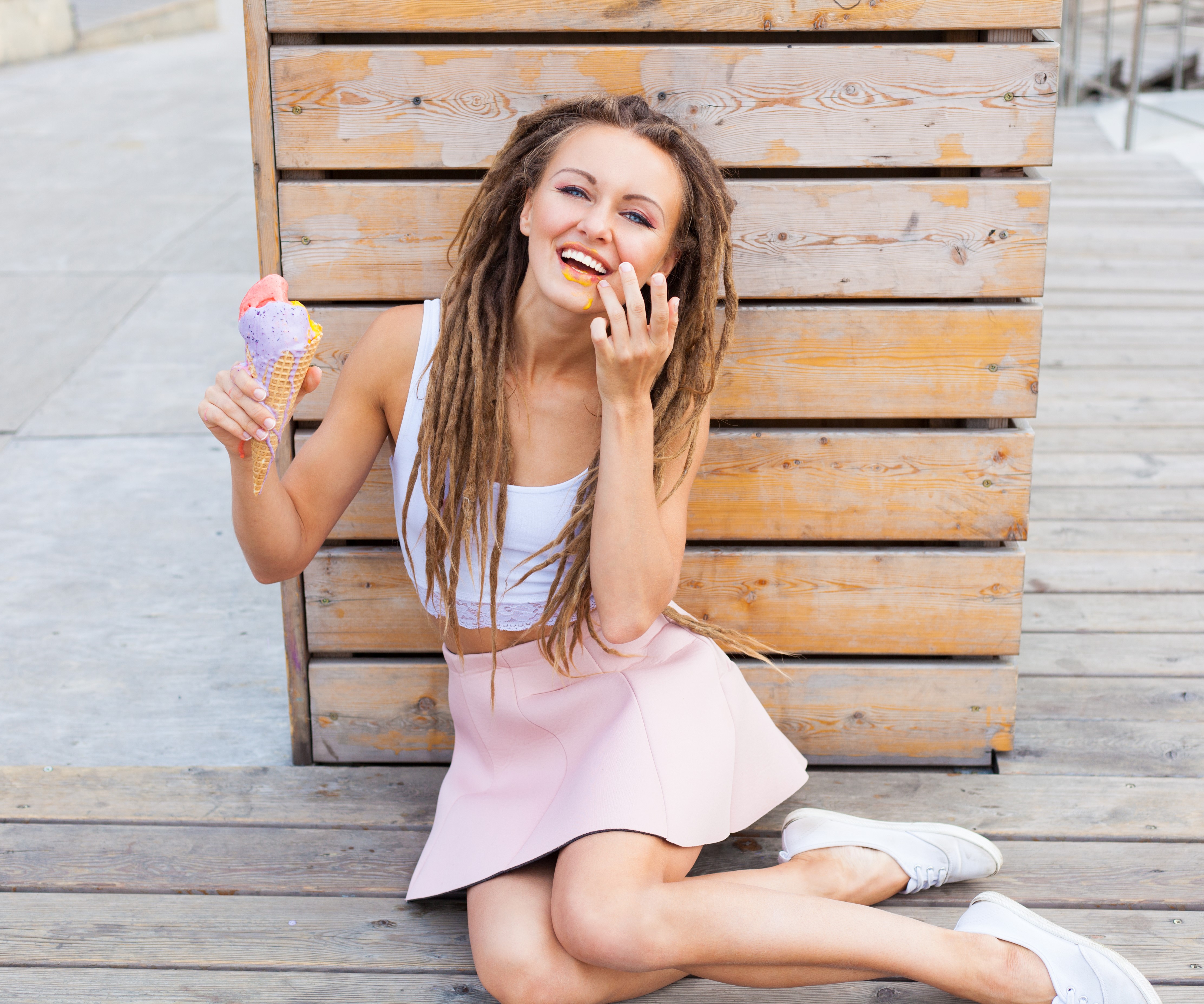 Woman with dreads eating ice cream HD Wallpaper
