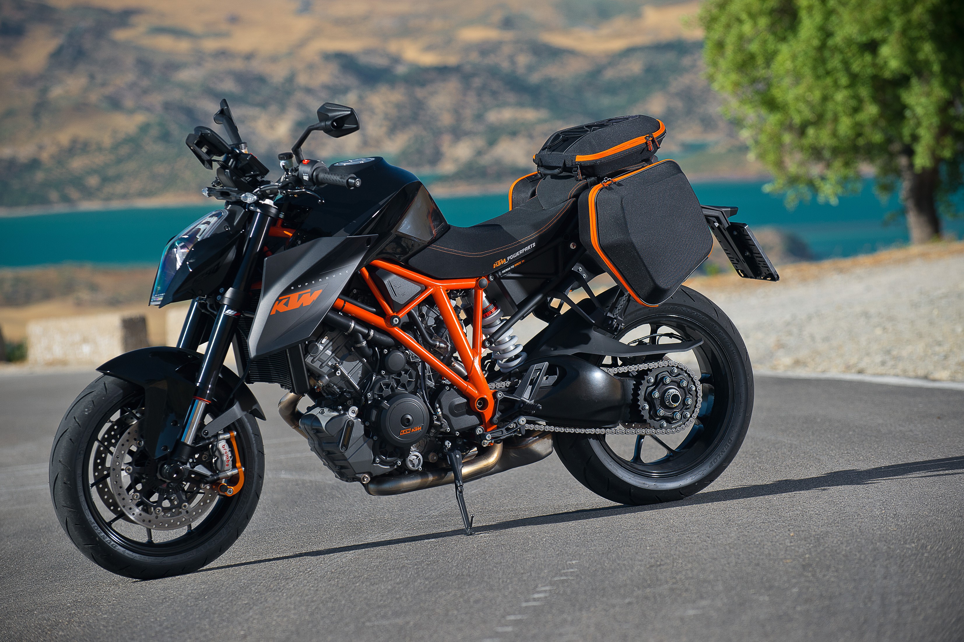 Black KTM 1290 Super Duke R motorcycle with saddlebags HD Wallpaper