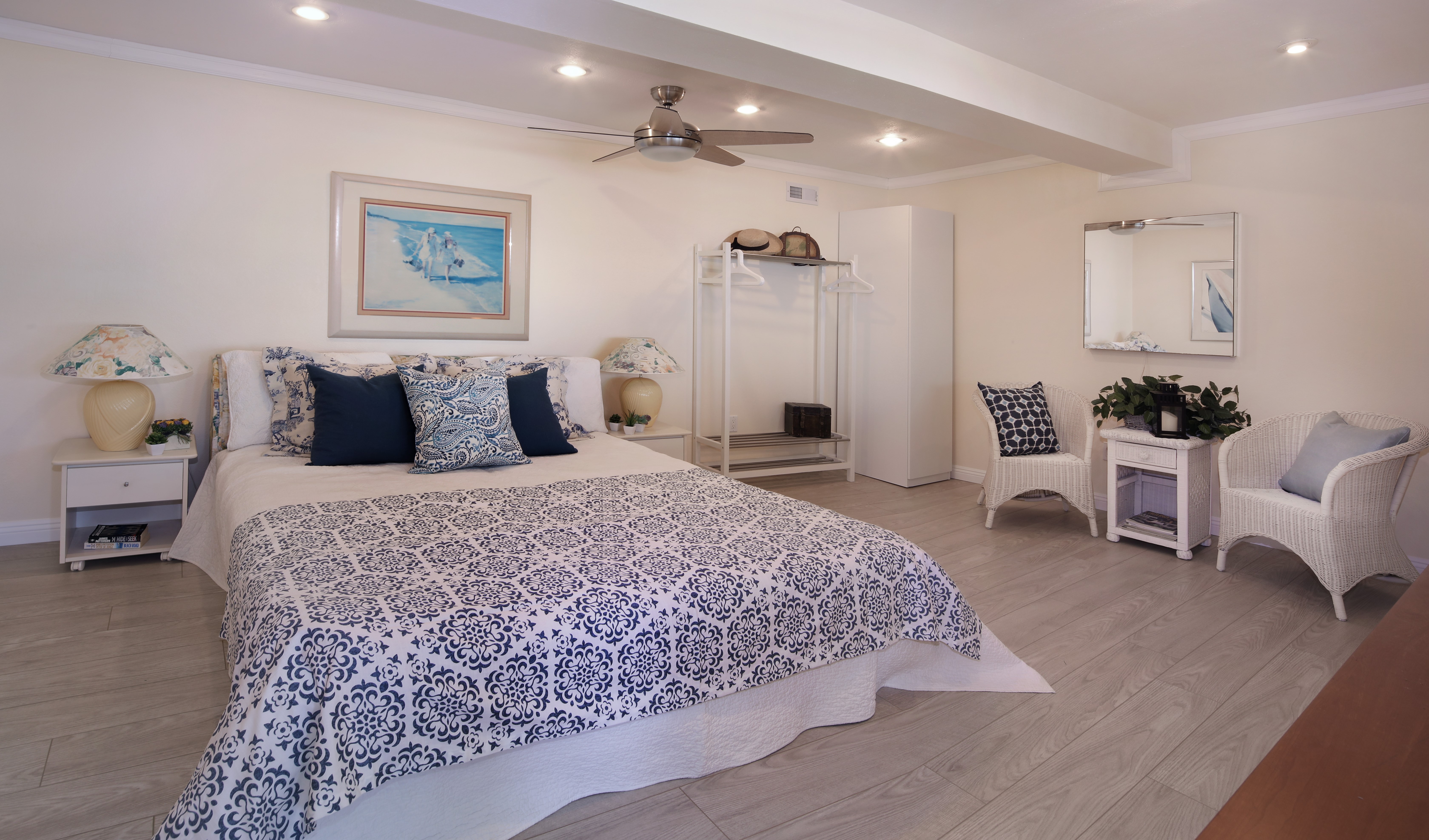 Bedroom with bed, pillows, armchair, and ceiling fan HD Wallpaper