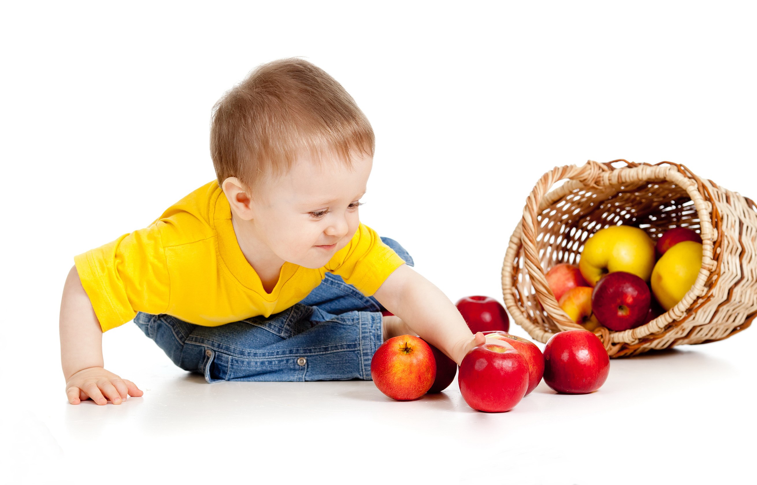 Baby boy in yellow shirt reaching for apples HD Wallpaper
