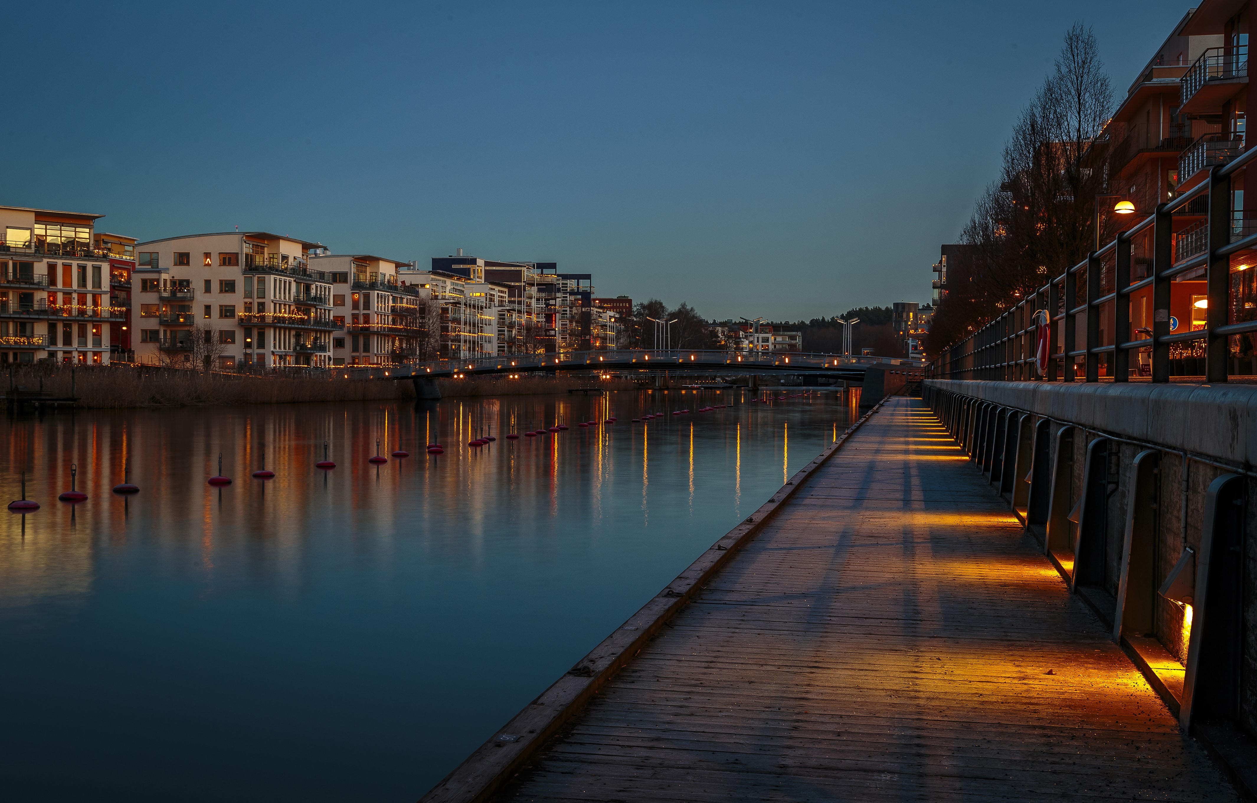 Apartment buildings along a river at dusk in Stockholm, Sweden HD Wallpaper