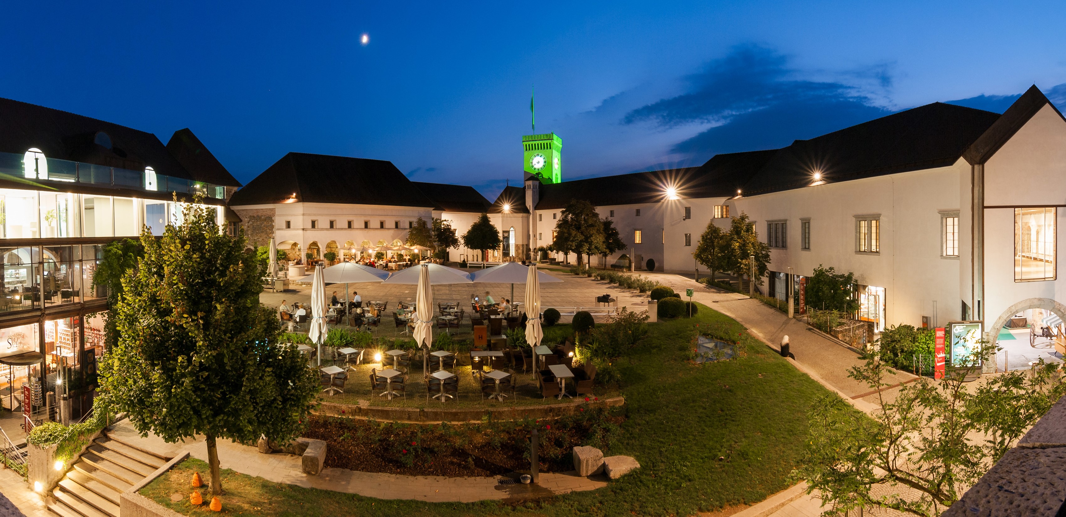 Ljubljana Castle courtyard at dusk with outdoor cafe HD Wallpaper