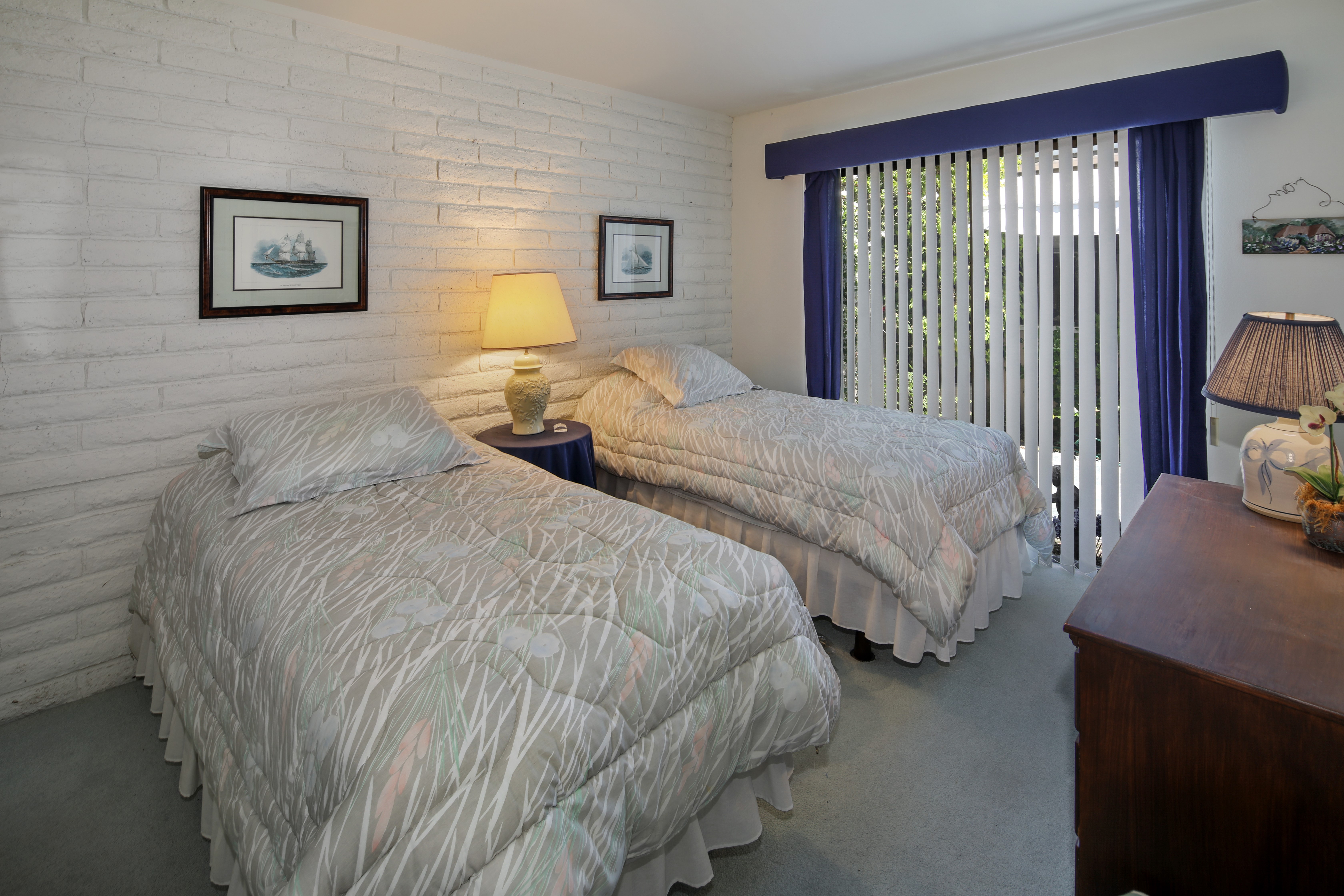 Bedroom with two beds and white brick wall HD Wallpaper