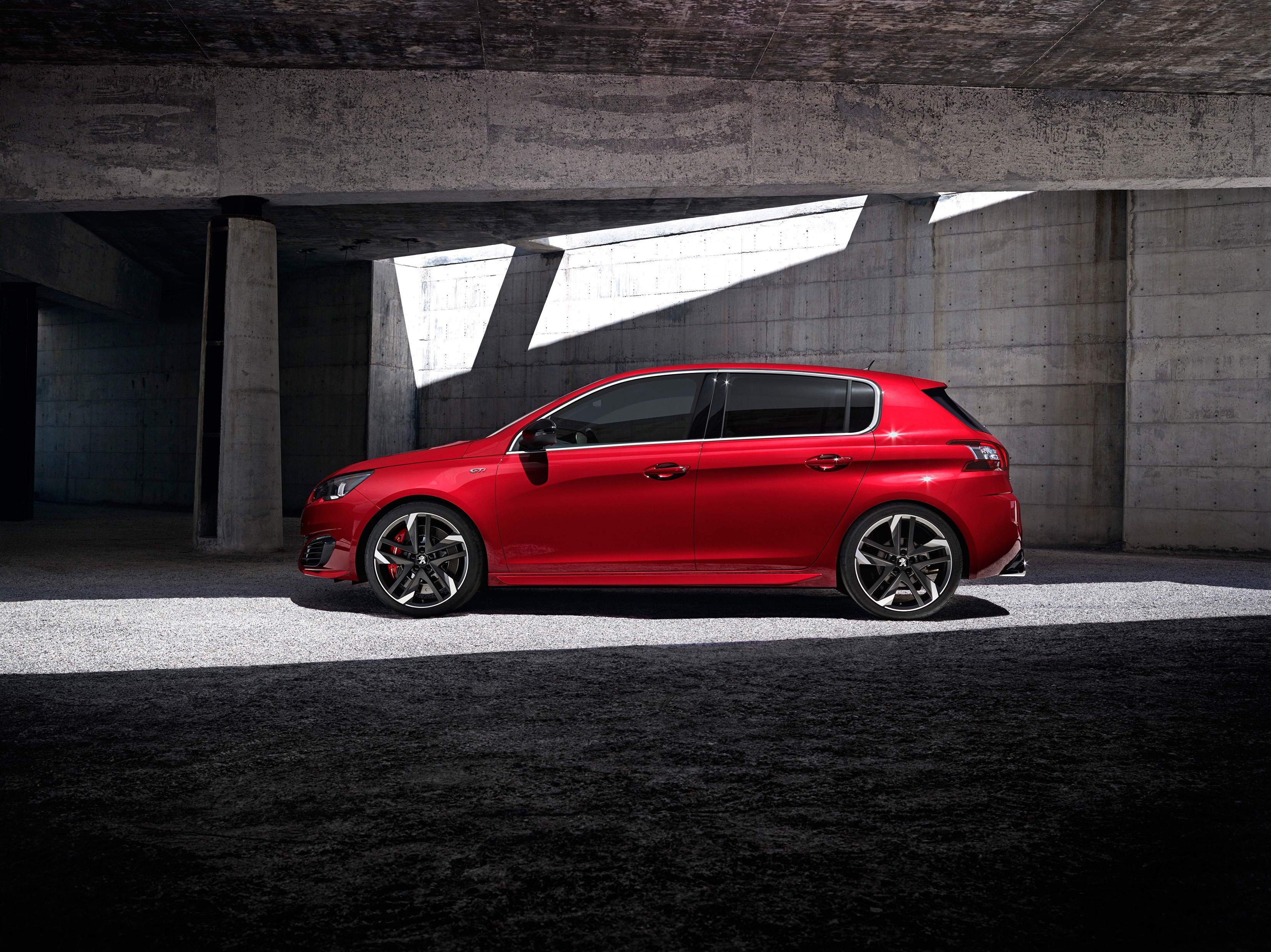 Red Peugeot 308 GTi parked under concrete structure HD Wallpaper