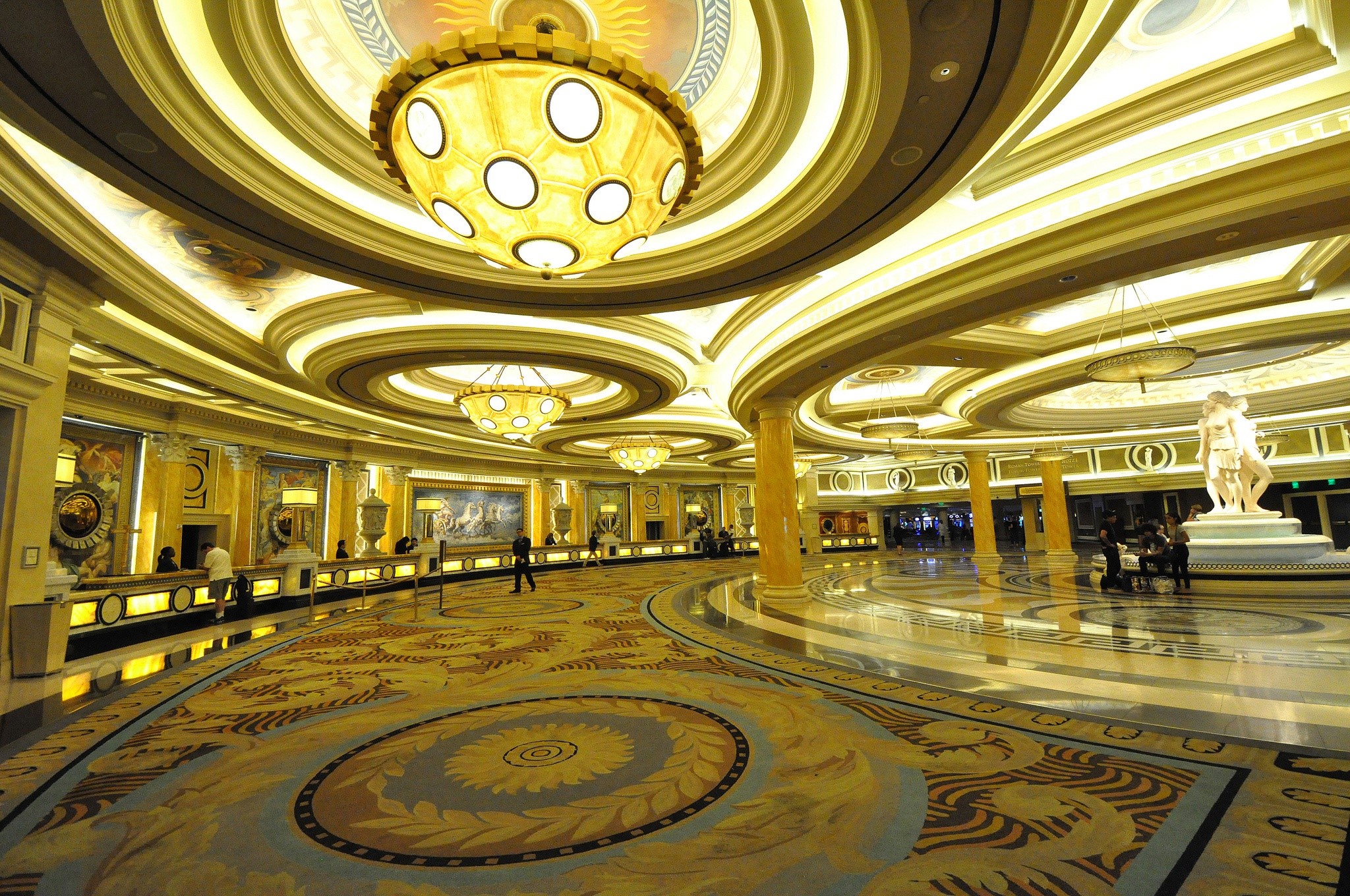 Caesars Palace interior lobby with chandeliers and statues HD Wallpaper