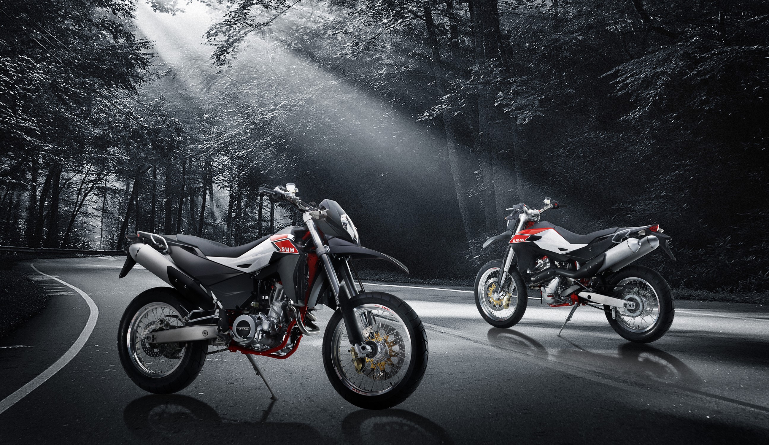 Two SWM Superdual 650 motorcycles on a road HD Wallpaper