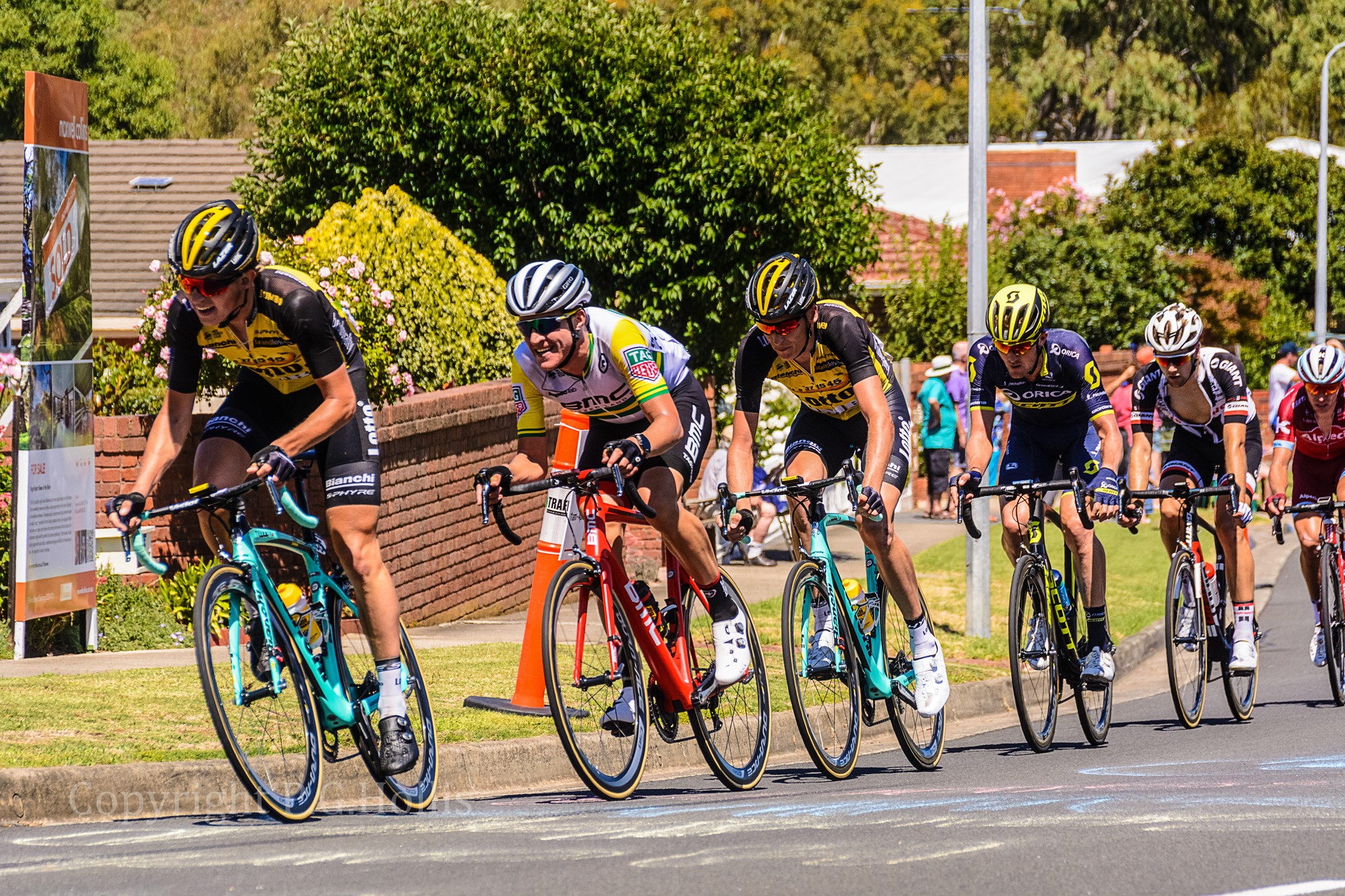 Cyclists in a race wearing helmets and cycling gear HD Wallpaper