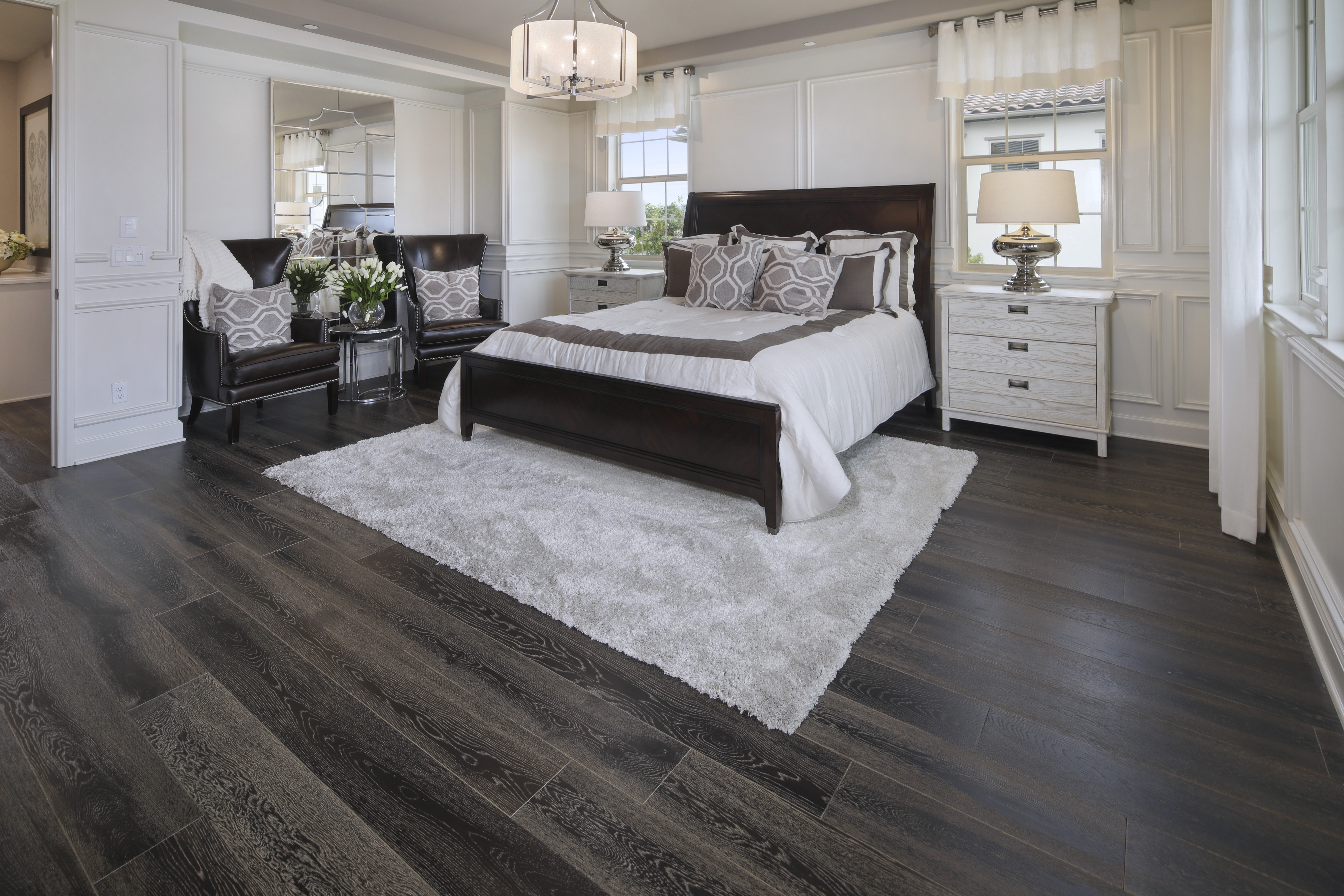 Bedroom with dark wood floor and white rug HD Wallpaper