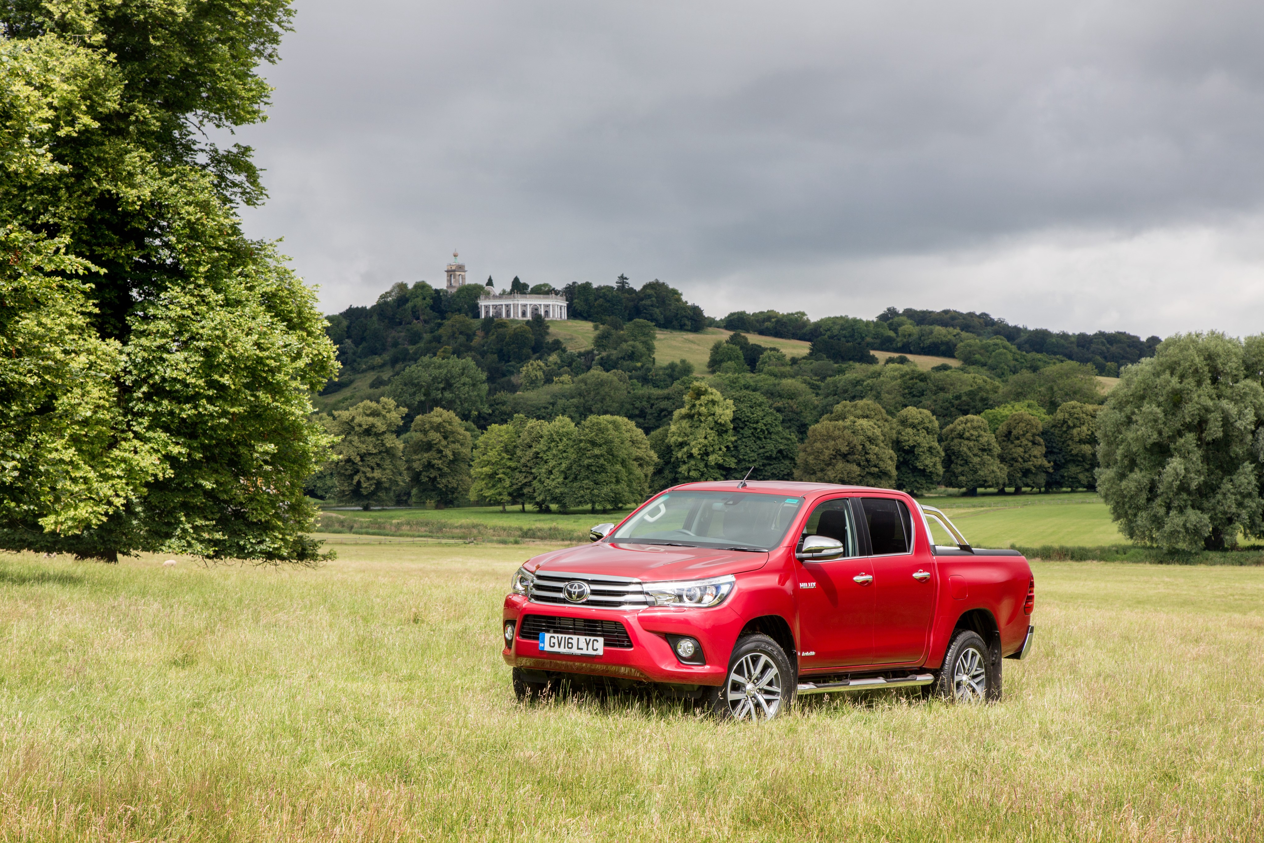 Red 2016 Toyota Hilux Invincible Double Cab in a field HD Wallpaper