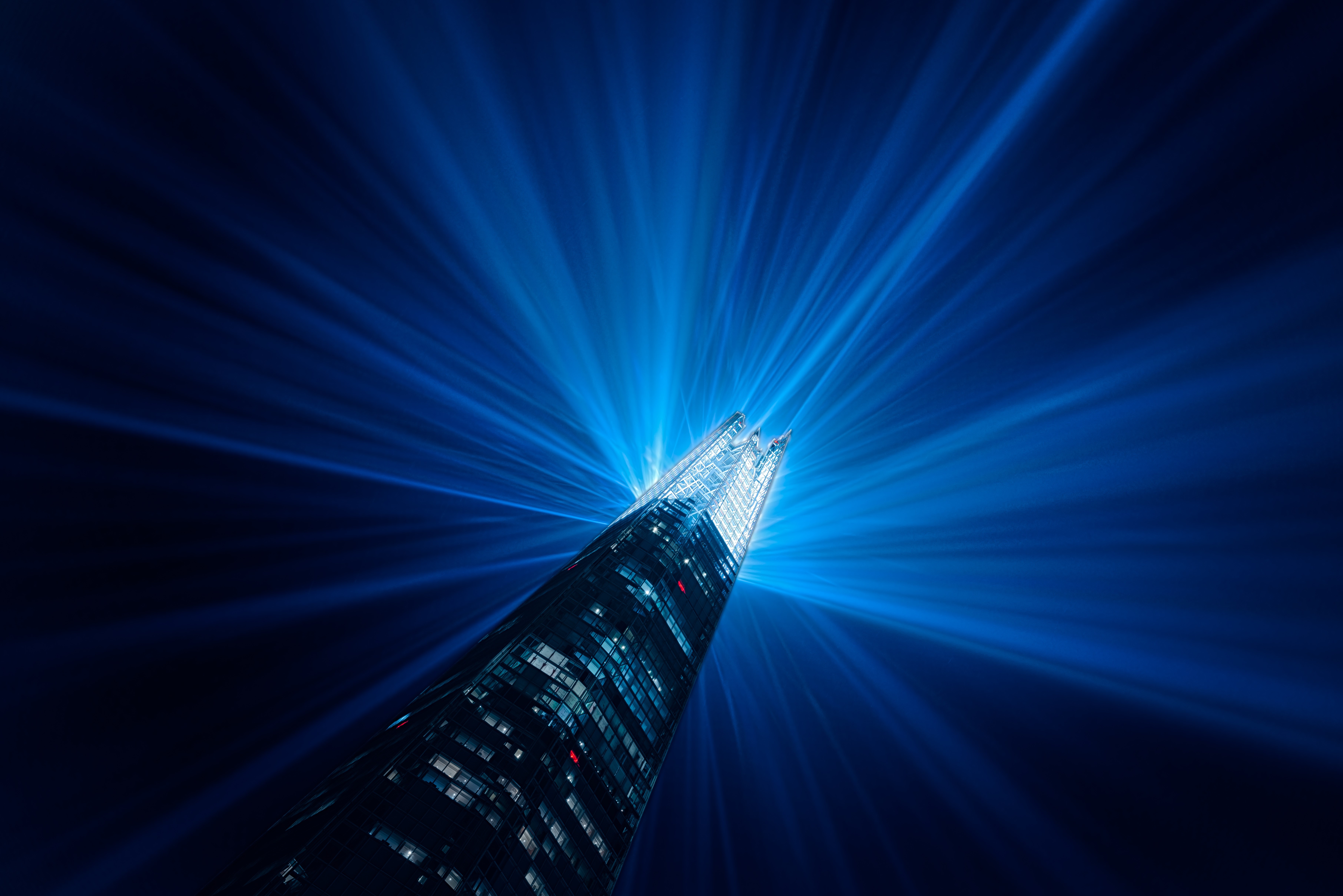 The Shard skyscraper with blue light rays at night in London HD Wallpaper