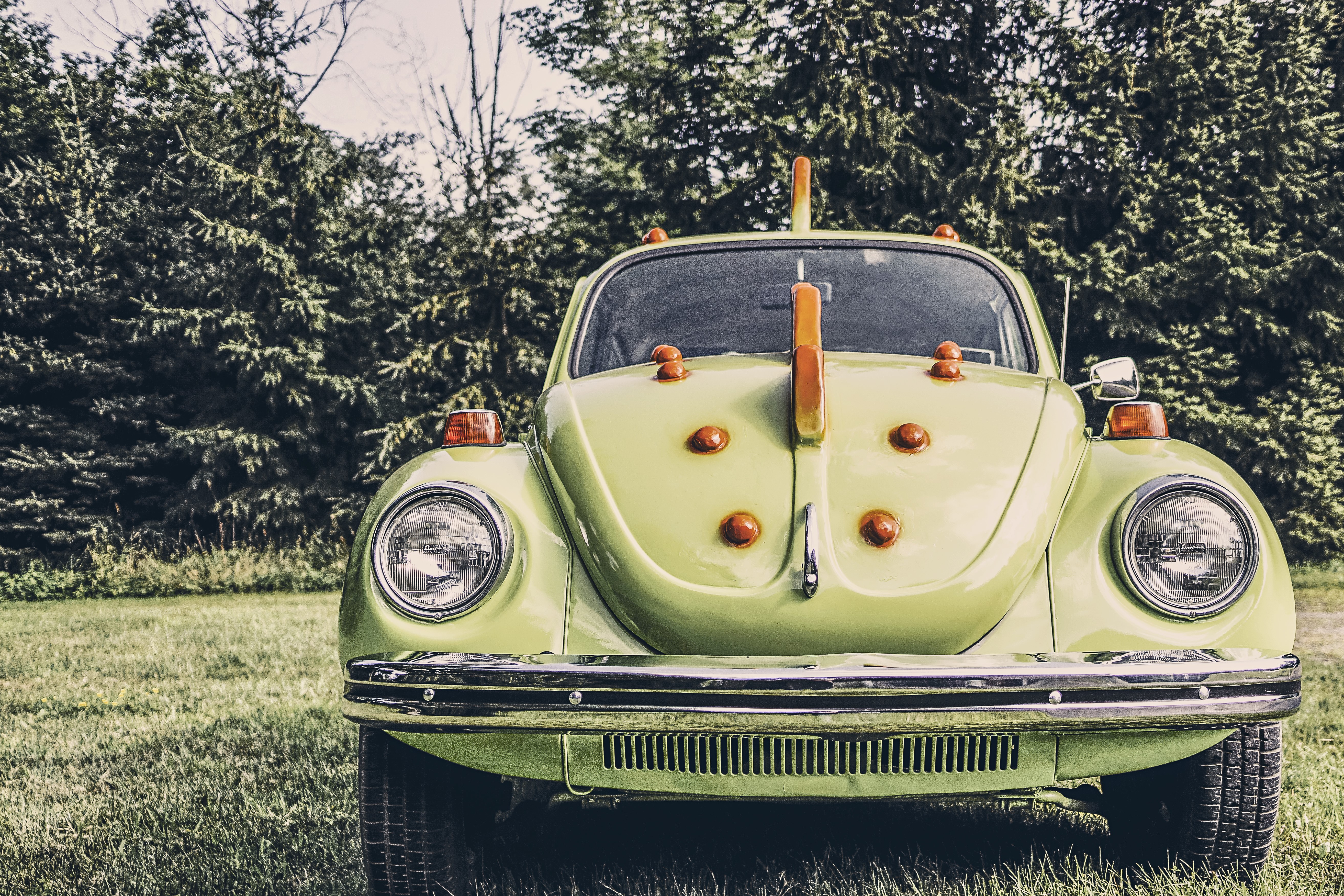 Green Volkswagen Beetle with orange accents HD Wallpaper