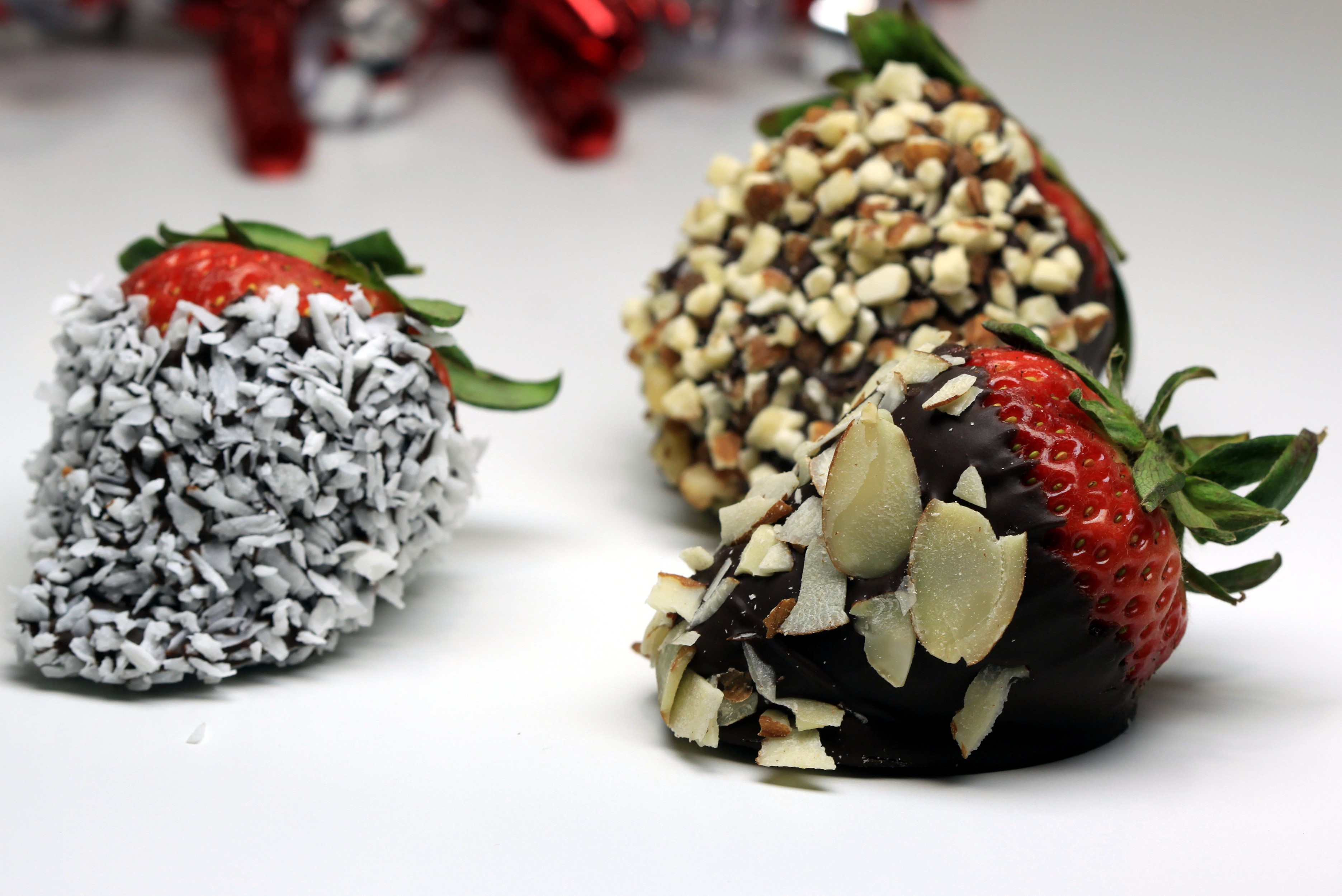 Chocolate covered strawberries with nuts and coconut HD Wallpaper