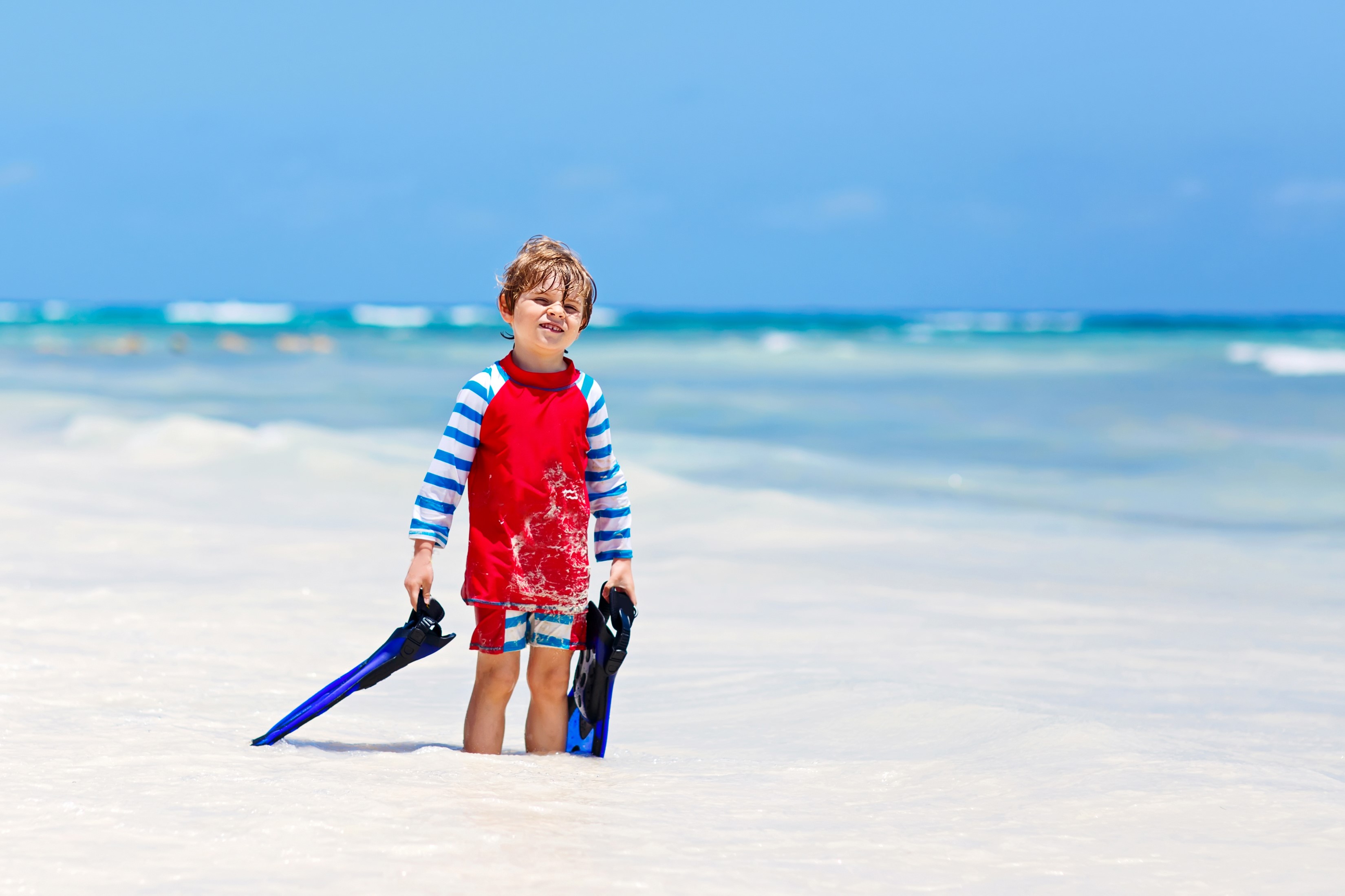 Boy with flippers on a beach HD Wallpaper