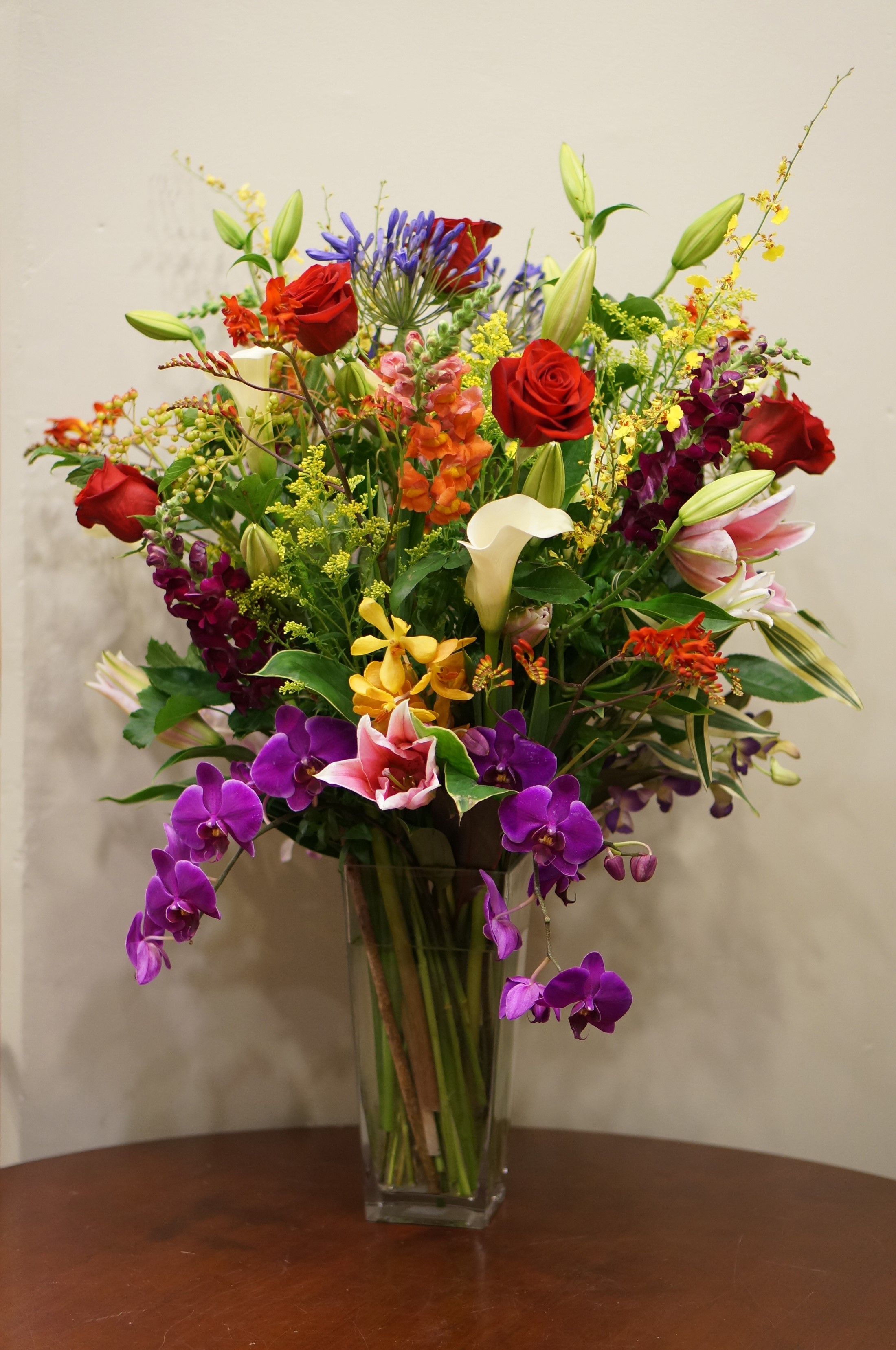 Vase of mixed flowers including roses and orchids HD Phone Wallpaper