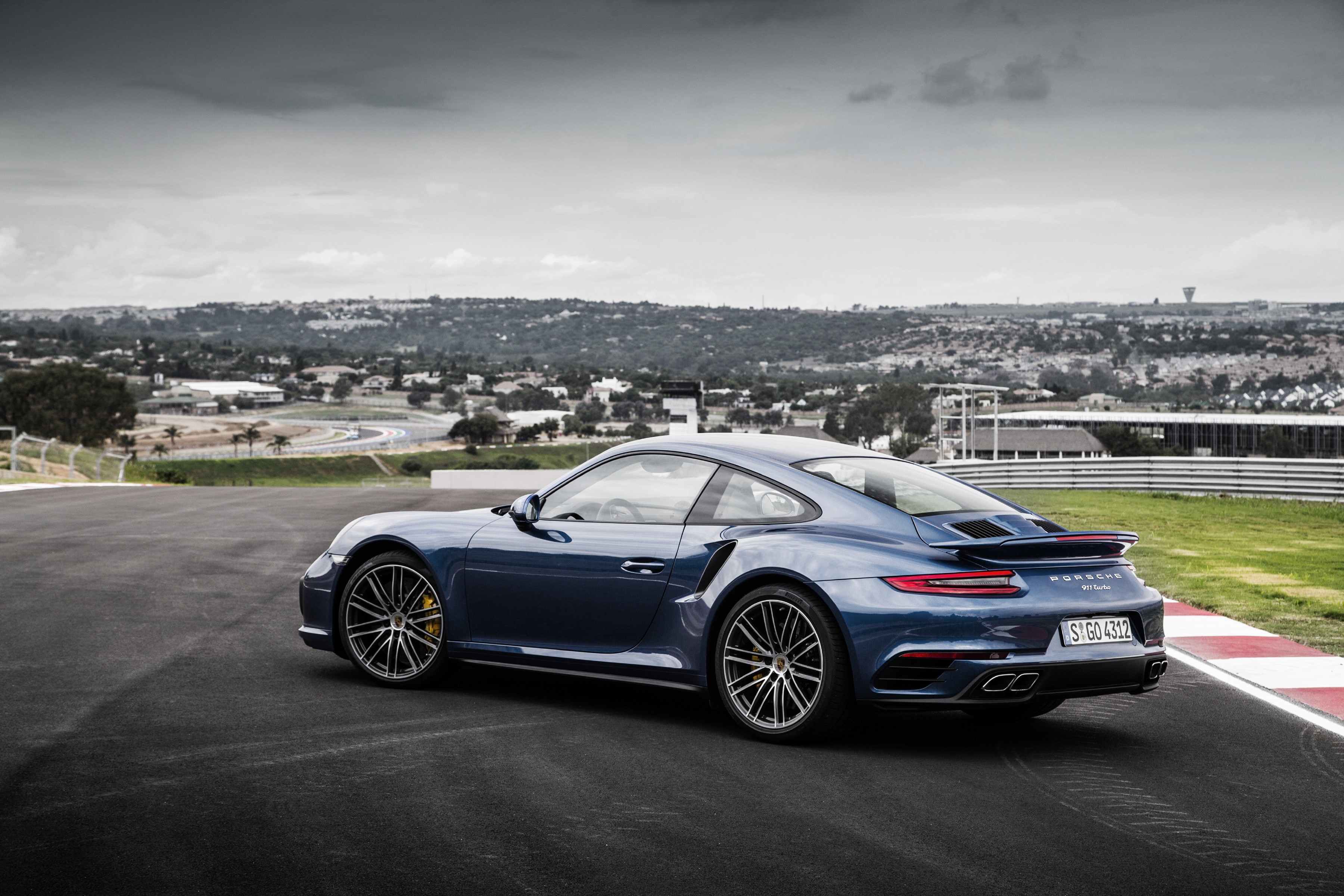 Blue Porsche 911 Turbo S Coupe on a Racetrack HD Wallpaper