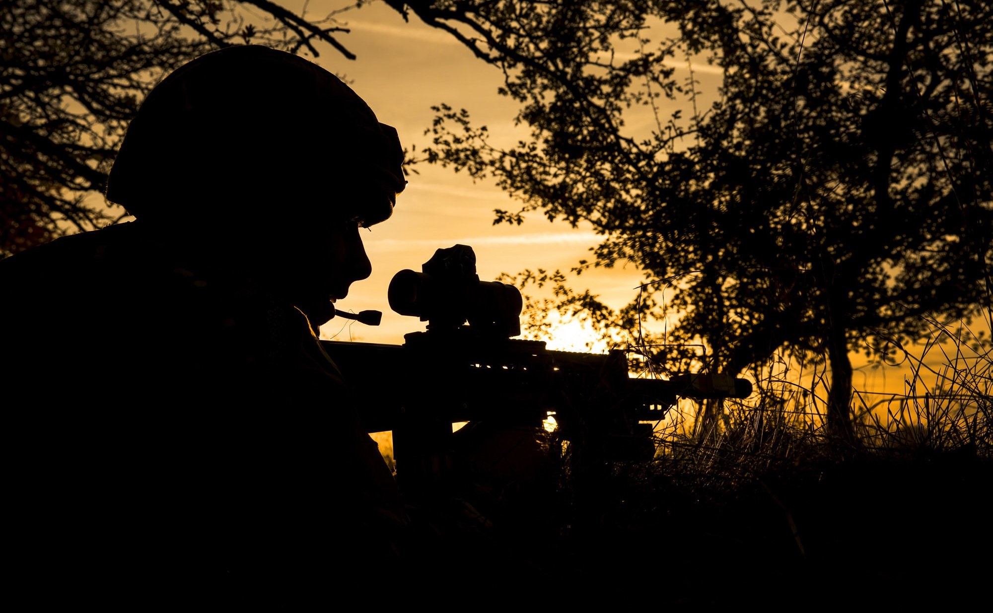 Soldier aiming assault rifle at sunset HD Wallpaper