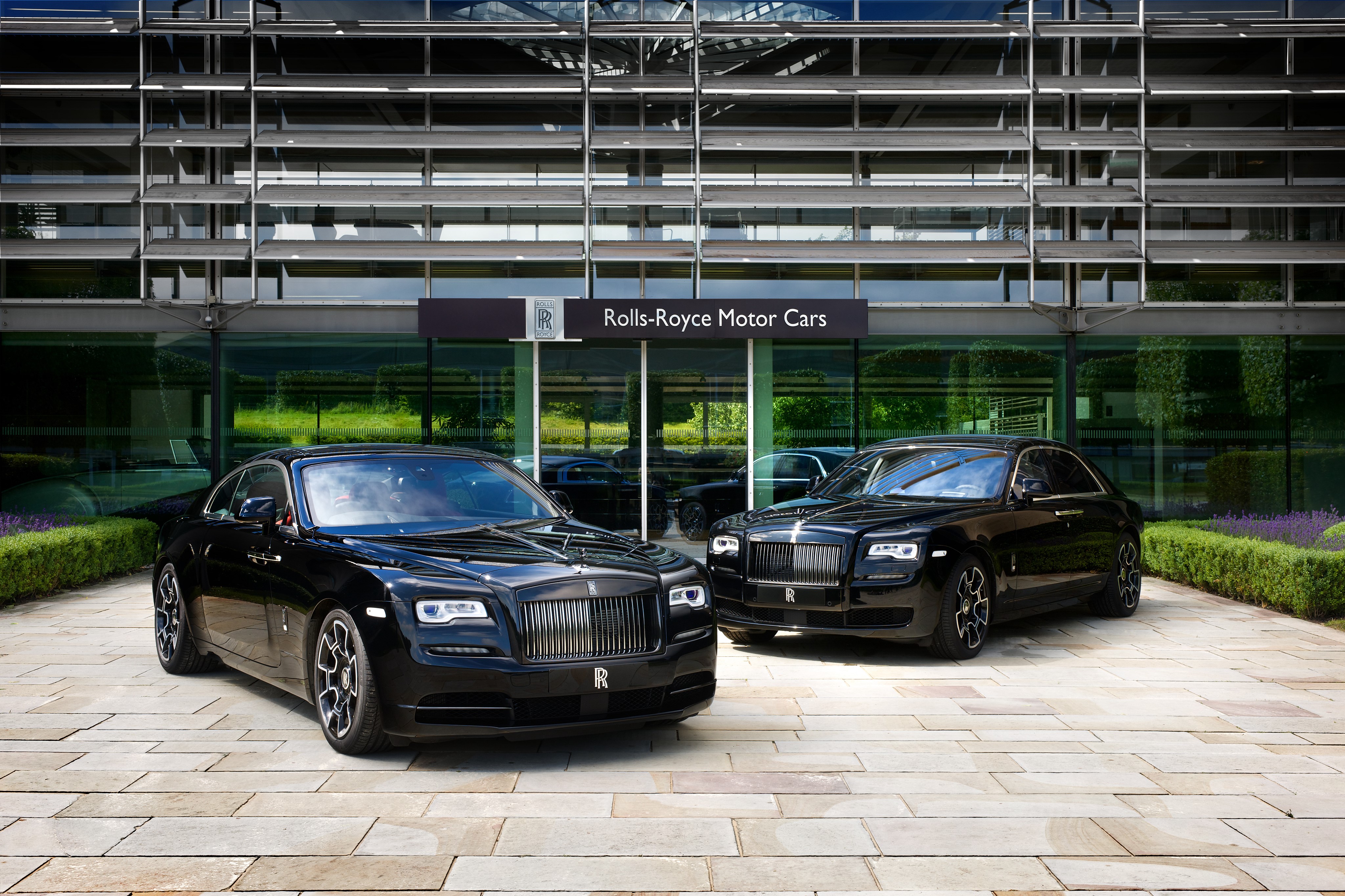Two black Rolls-Royce cars outside Rolls-Royce Motor Cars building HD Wallpaper