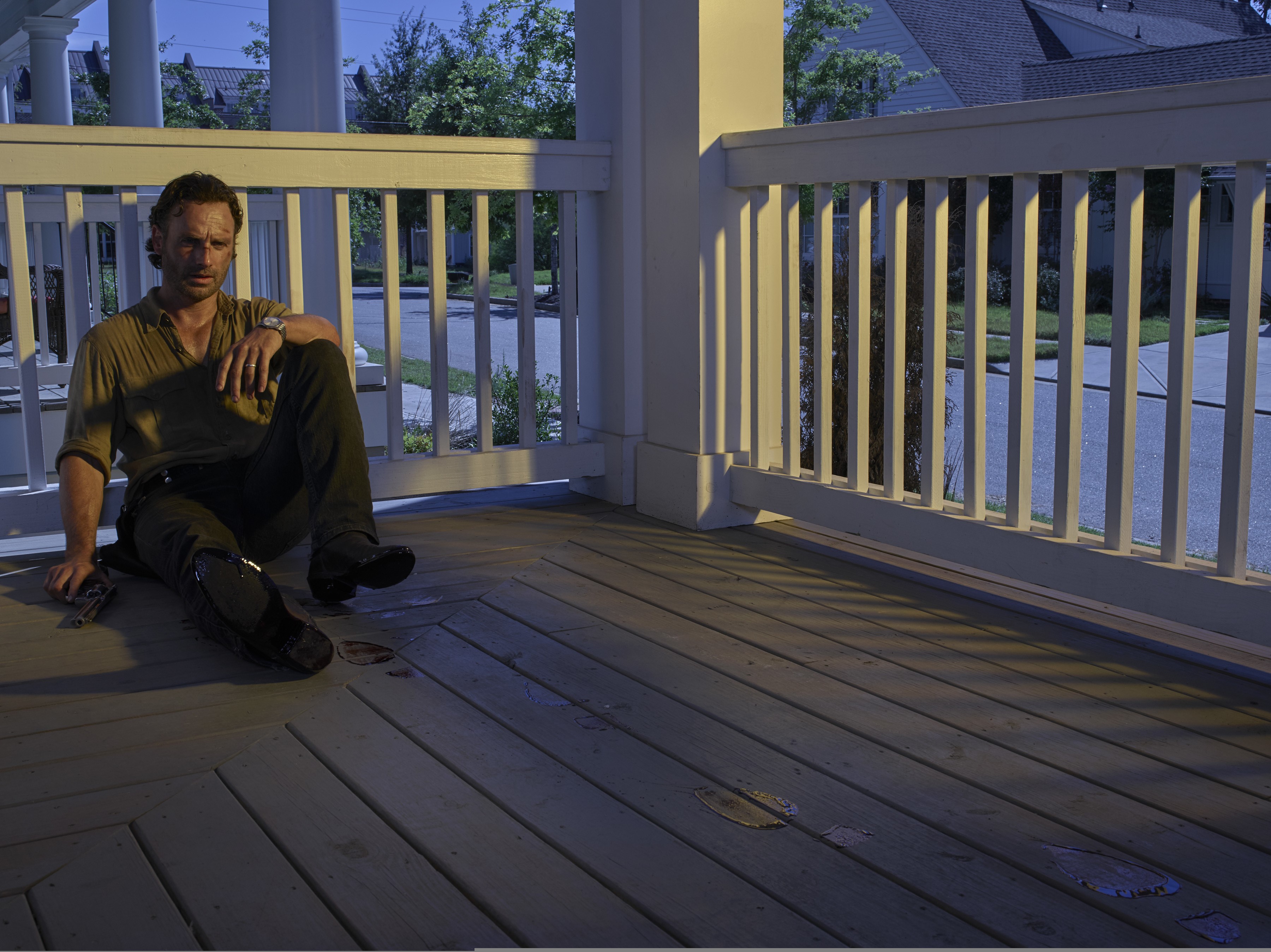 Rick Grimes from The Walking Dead sitting on a porch HD Wallpaper