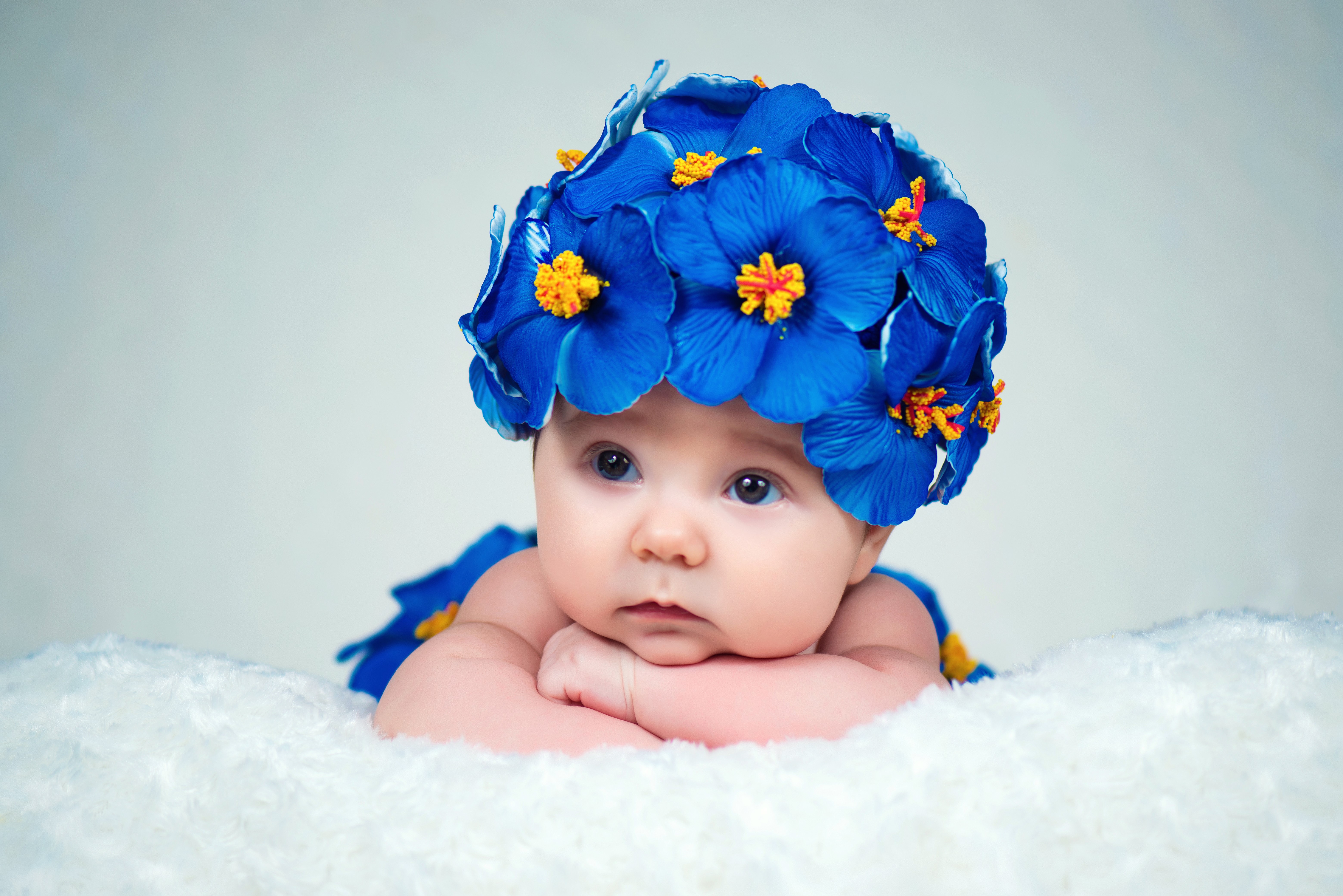 Baby wearing a blue flower hat HD Wallpaper