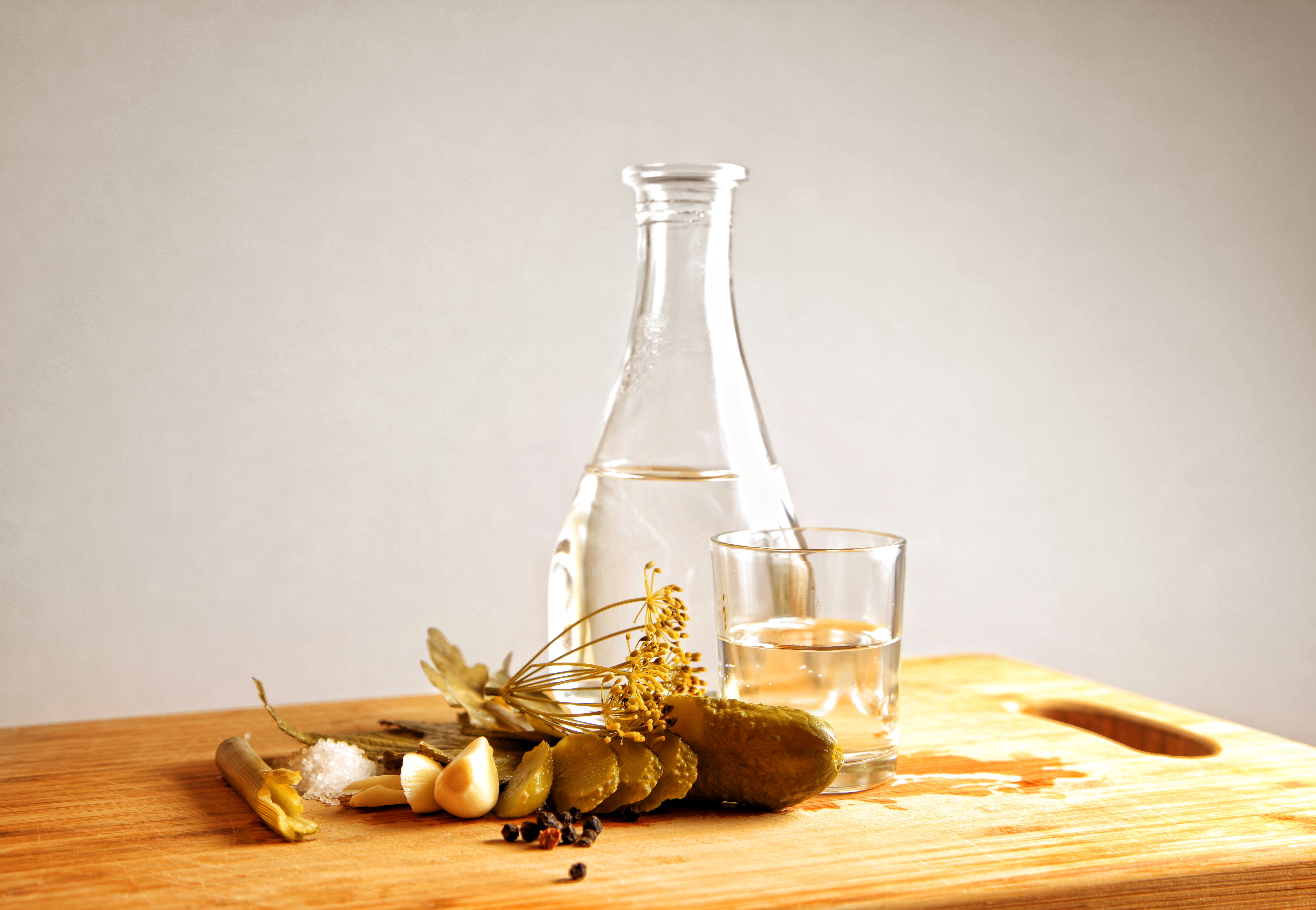 Vodka with Cucumbers, Dill, and Spices on a Cutting Board HD Wallpaper