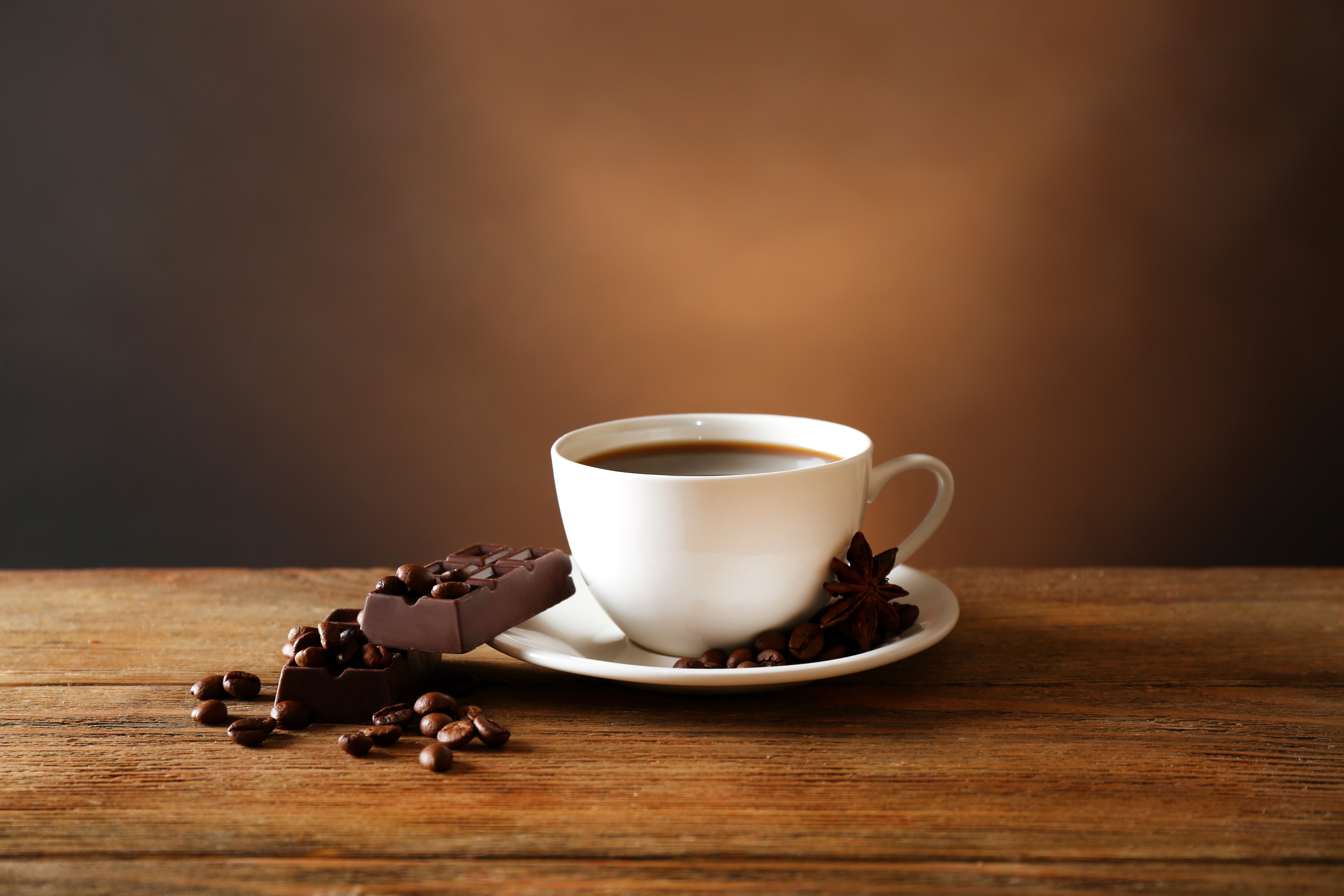 Coffee cup with chocolate and coffee beans on wood HD Wallpaper