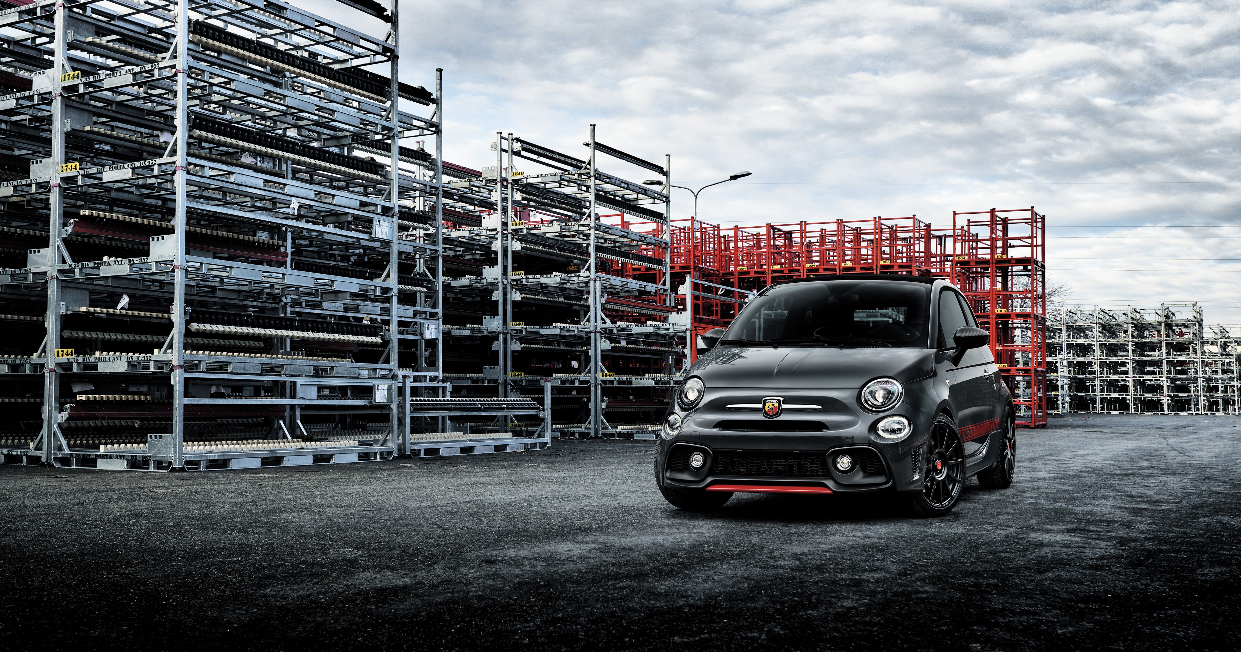 4K Abarth car in industrial storage yard HD Wallpaper