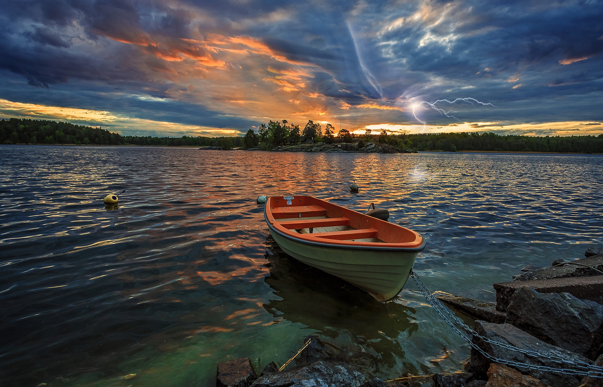Boat on a lake during a thunderstorm at sunset HD Wallpaper