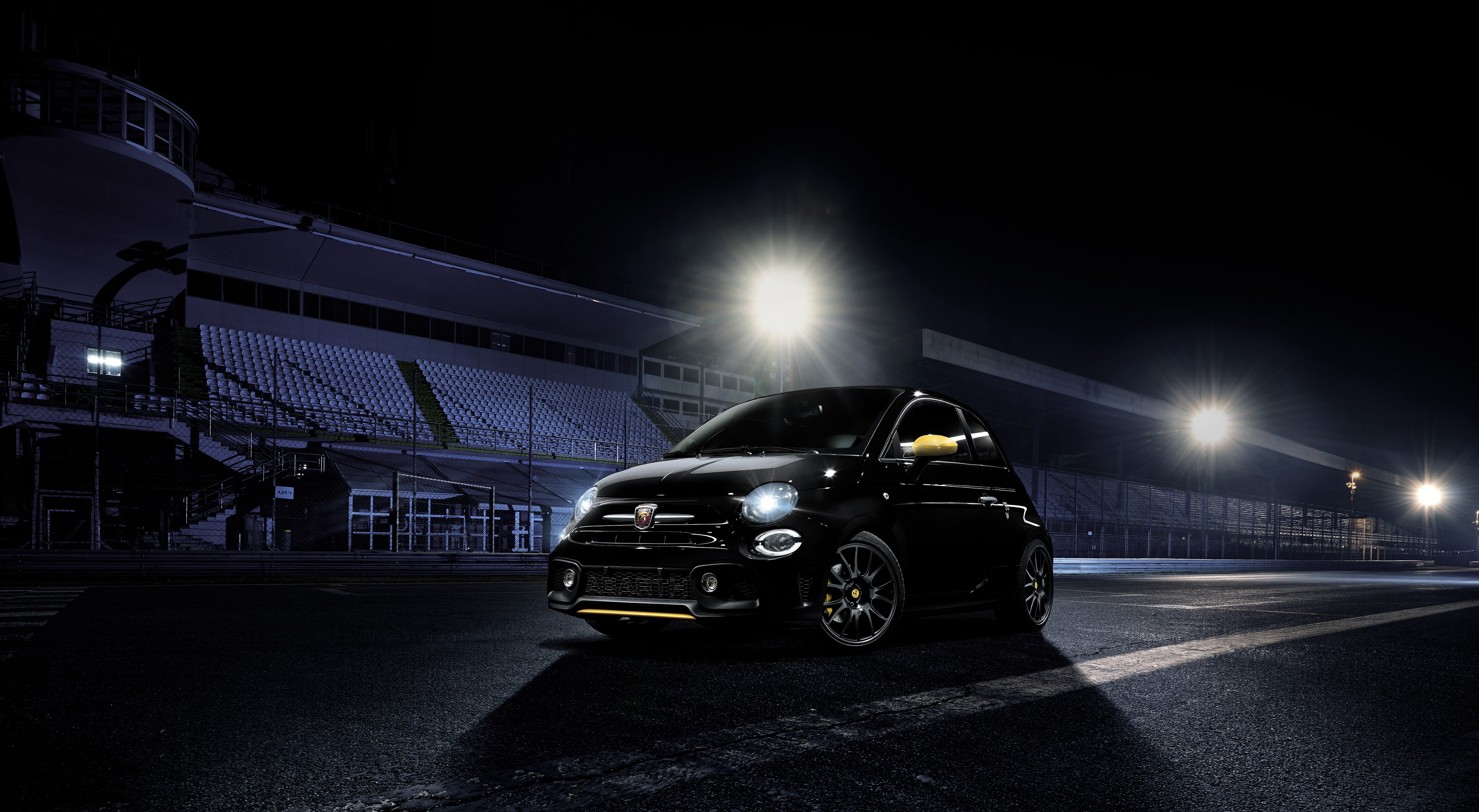 Black Abarth 500 at night on a race track HD Wallpaper