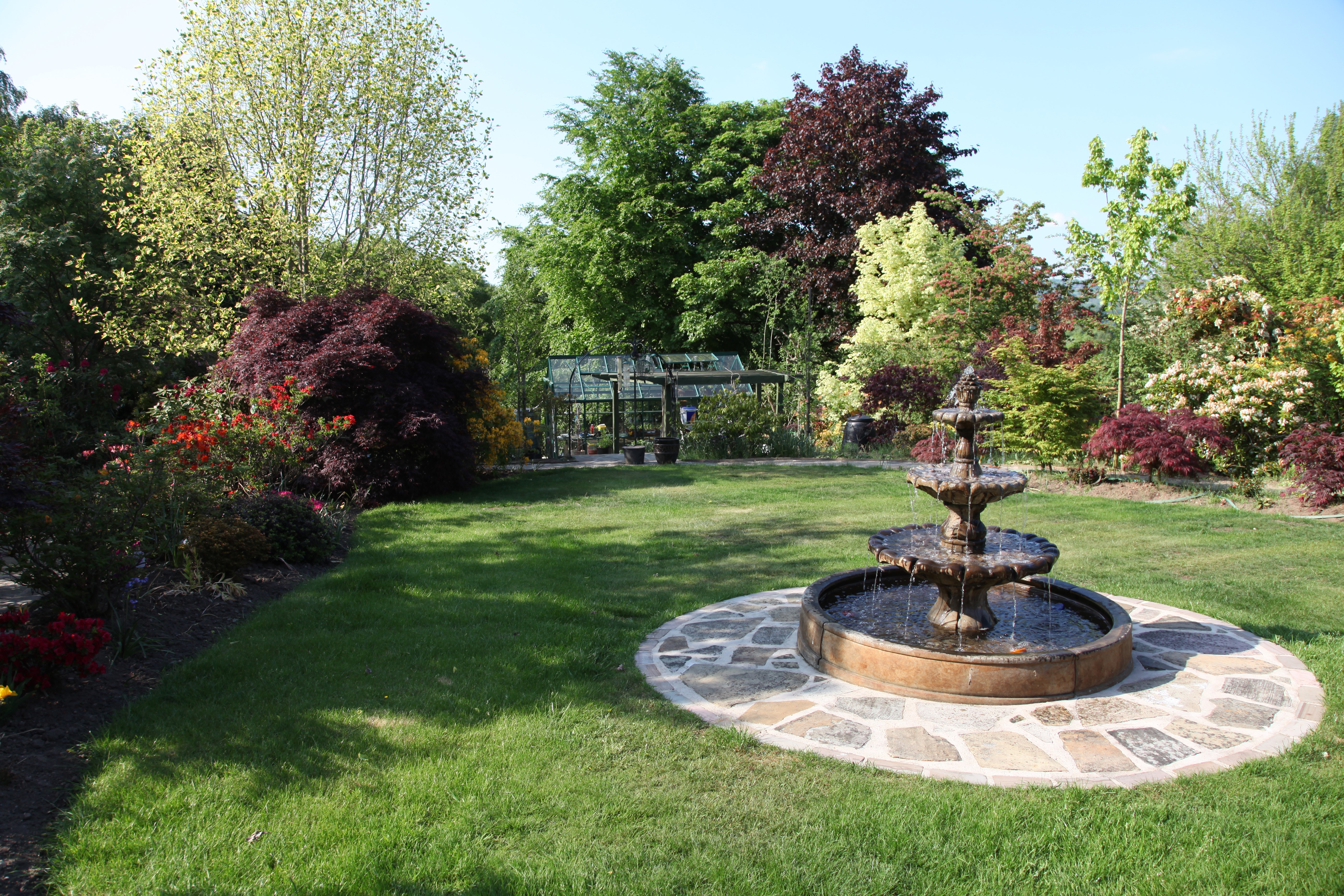 Garden with fountain and greenhouse HD Wallpaper