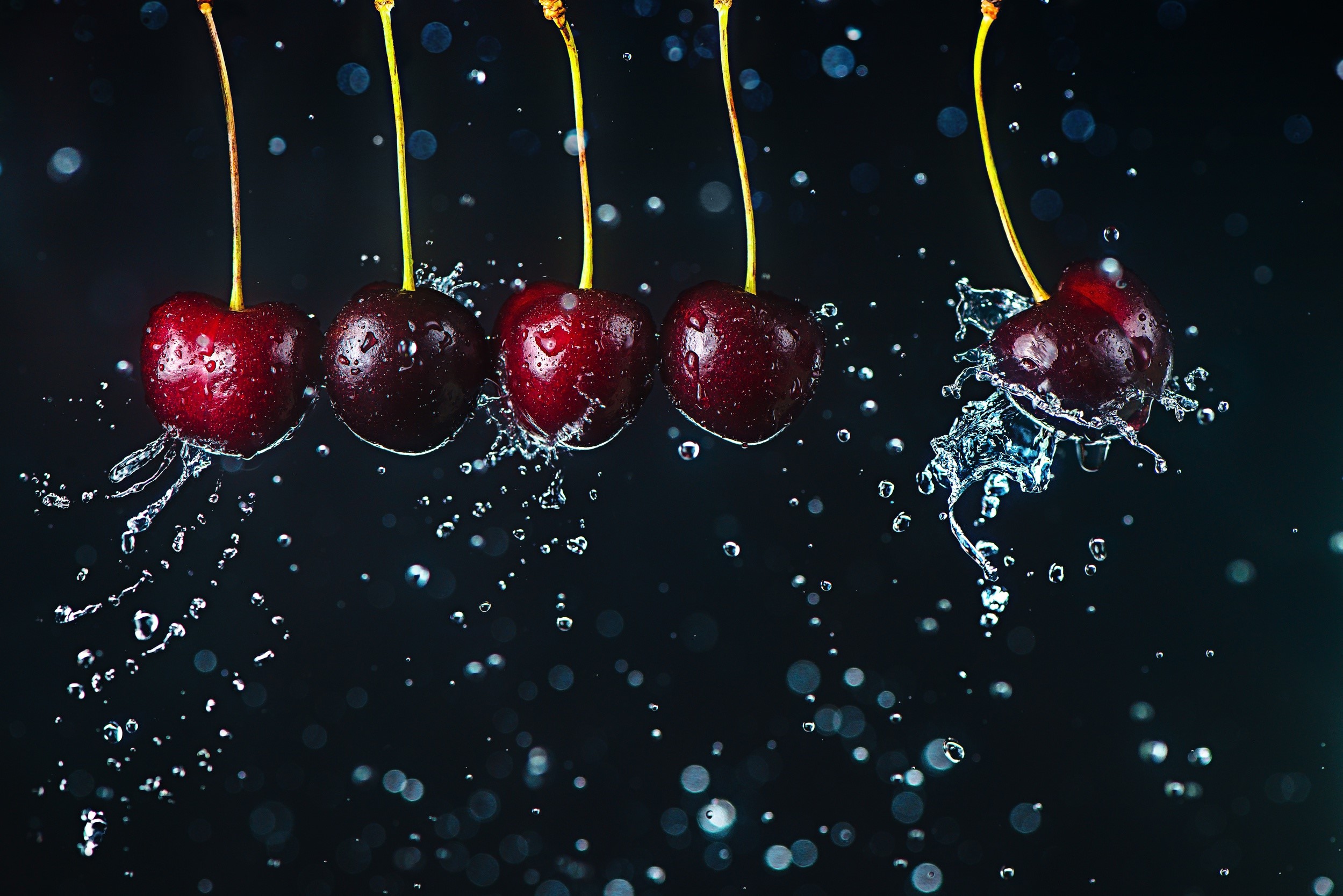 Cherries splashing in water HD Wallpaper