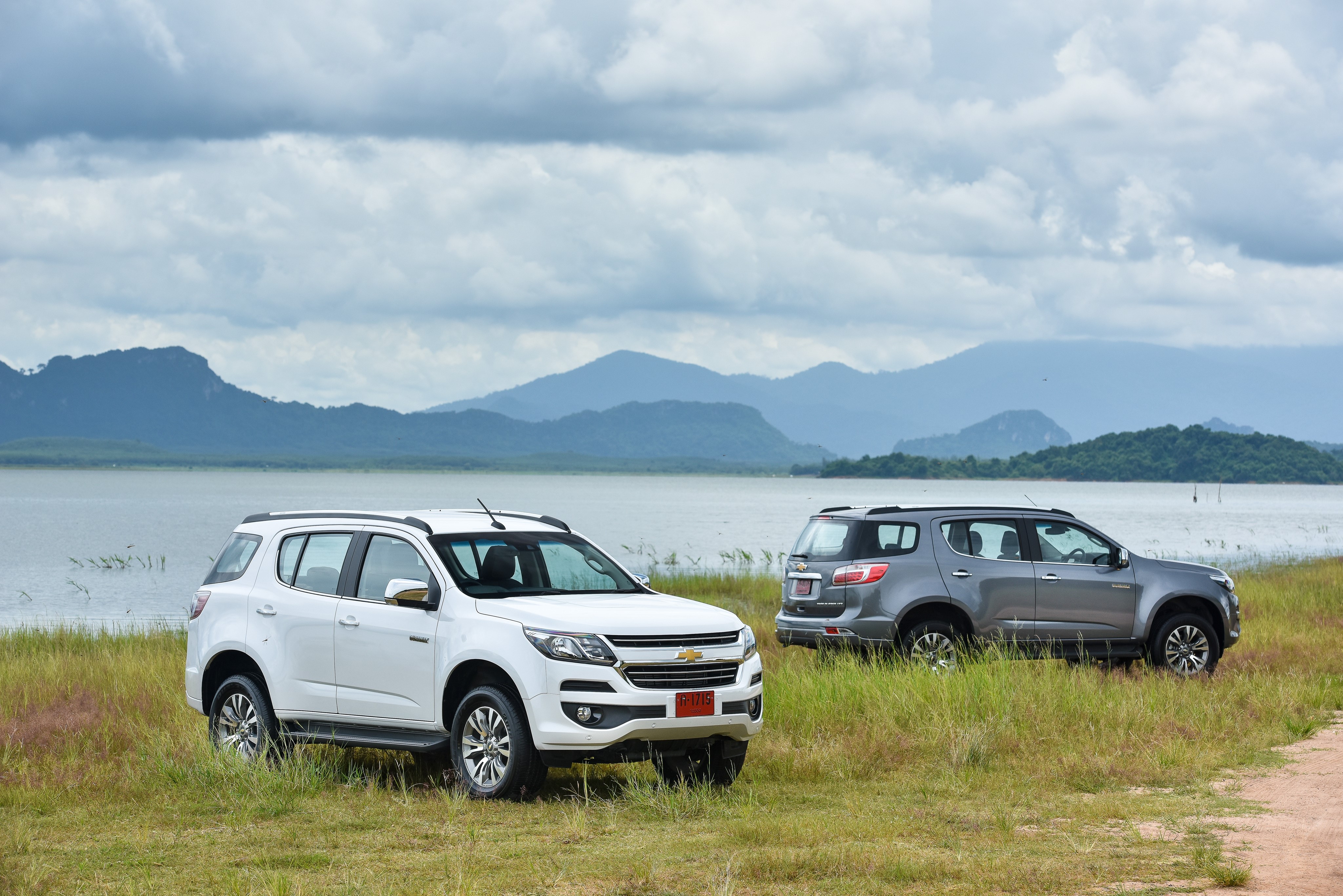 Two Chevrolet Trailblazer SUVs by a Lake HD Wallpaper