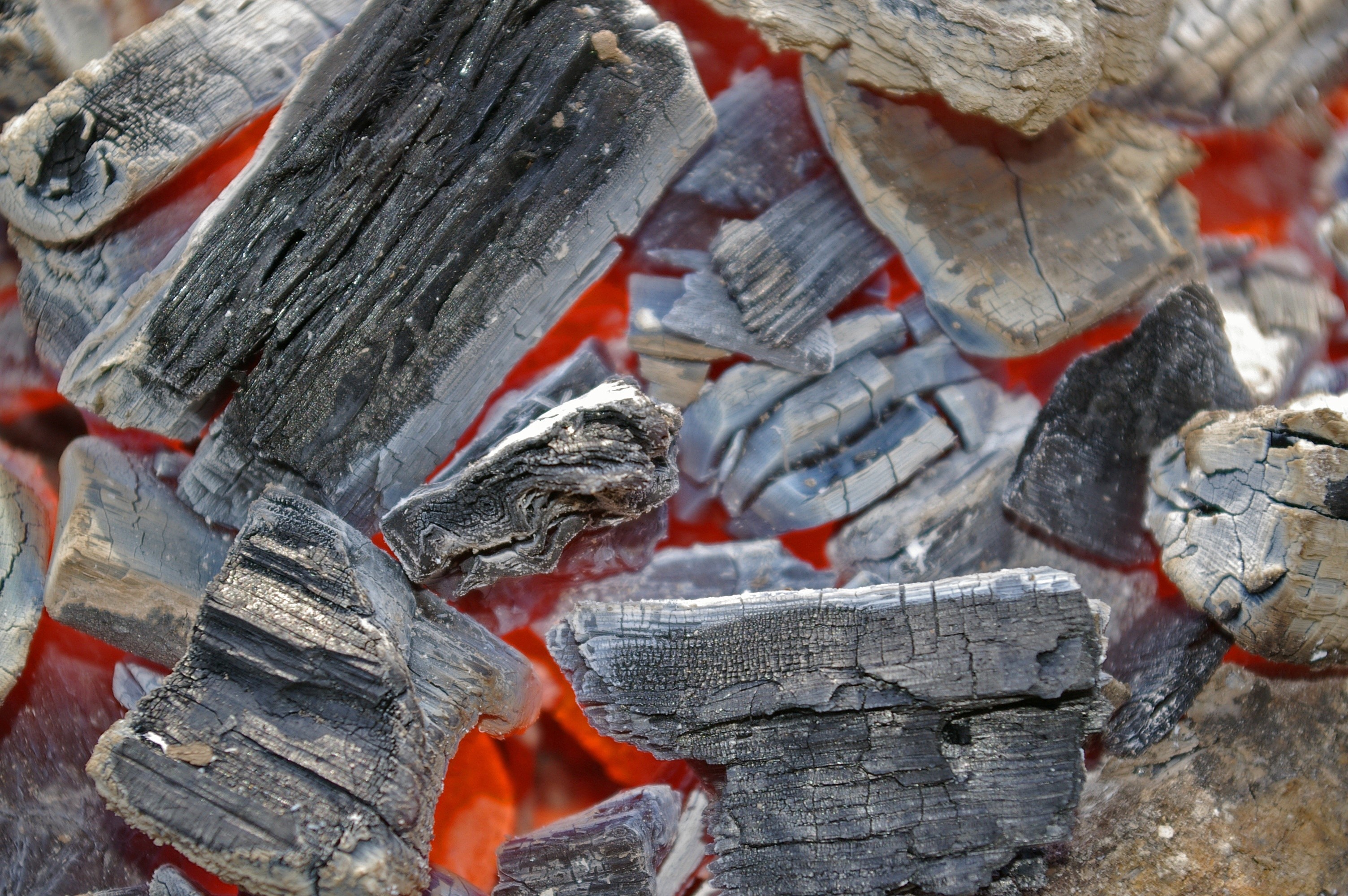 Macro view of smoldering coals in a bonfire HD Wallpaper