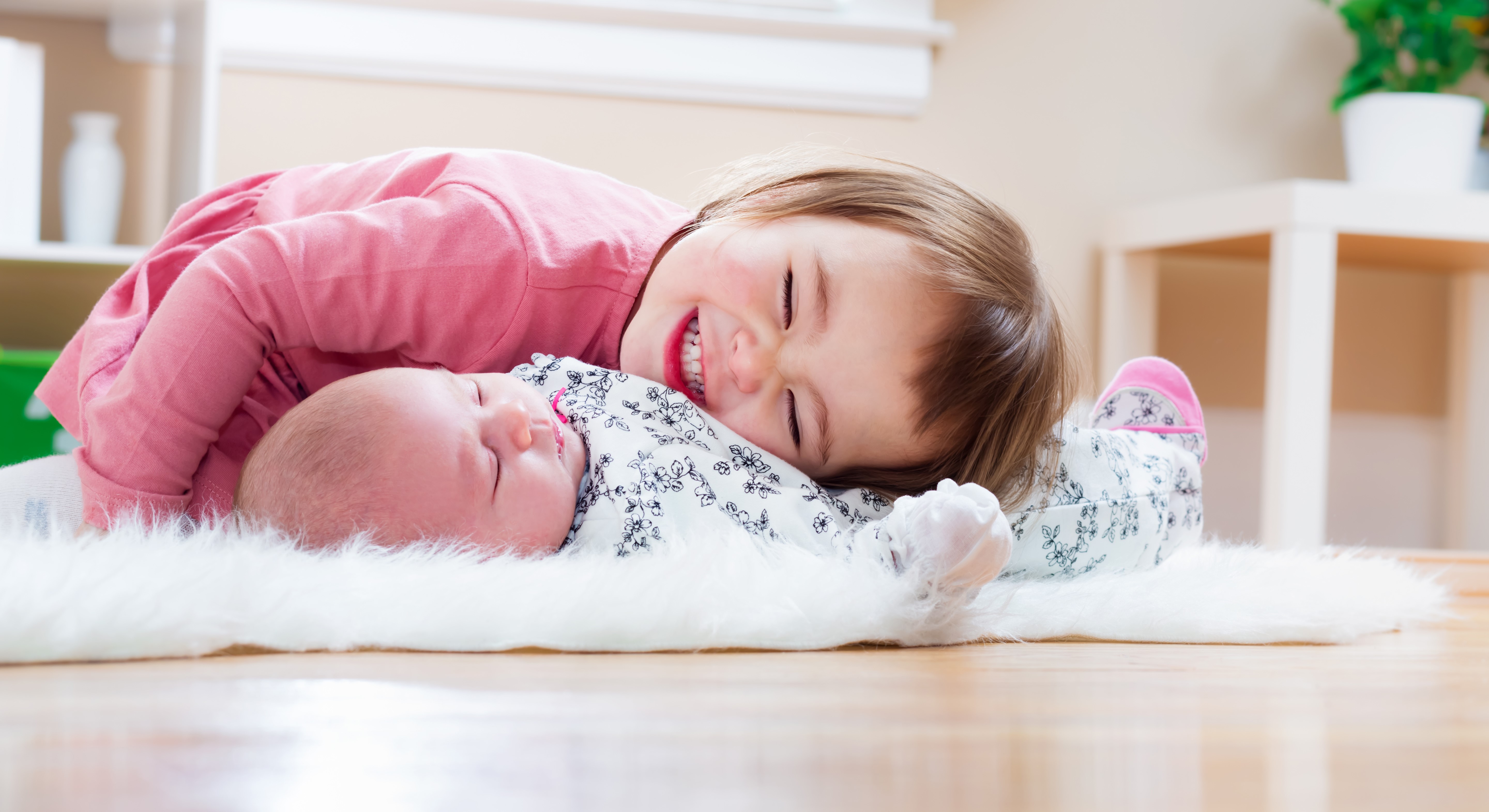 Two little girls, one infant, smiling HD Wallpaper