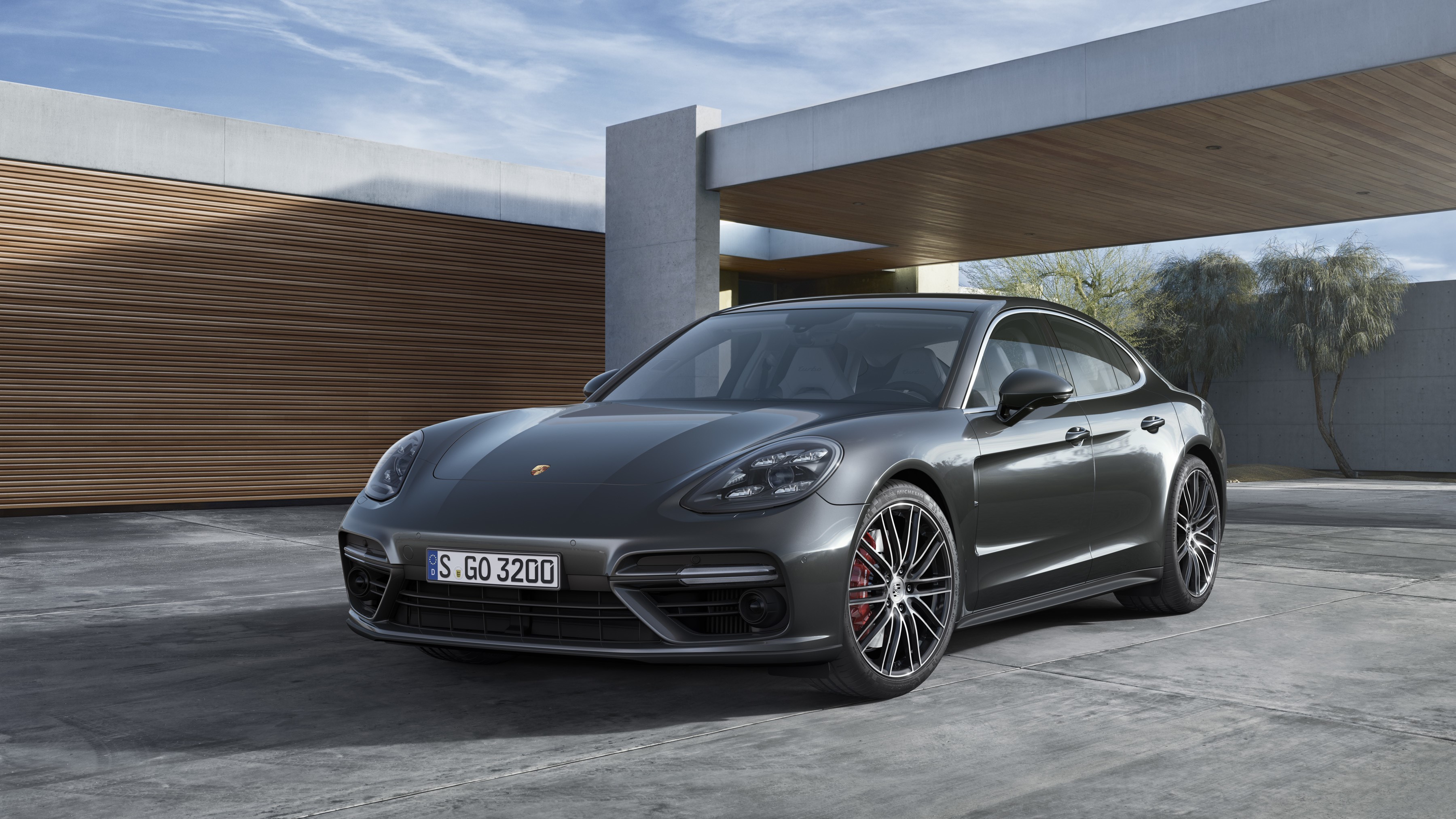 Grey Porsche Panamera parked outside modern building HD Wallpaper