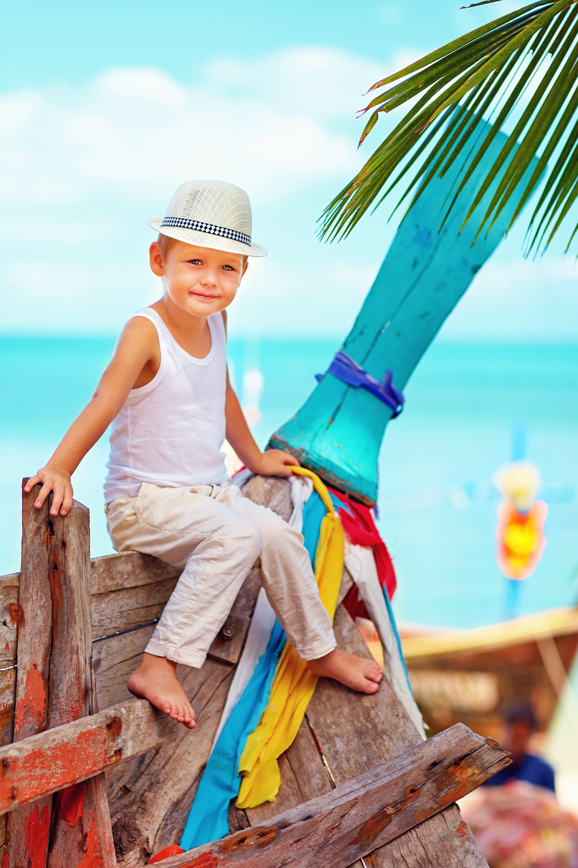 Boy in Hat Sitting on a Boat HD Phone Wallpaper