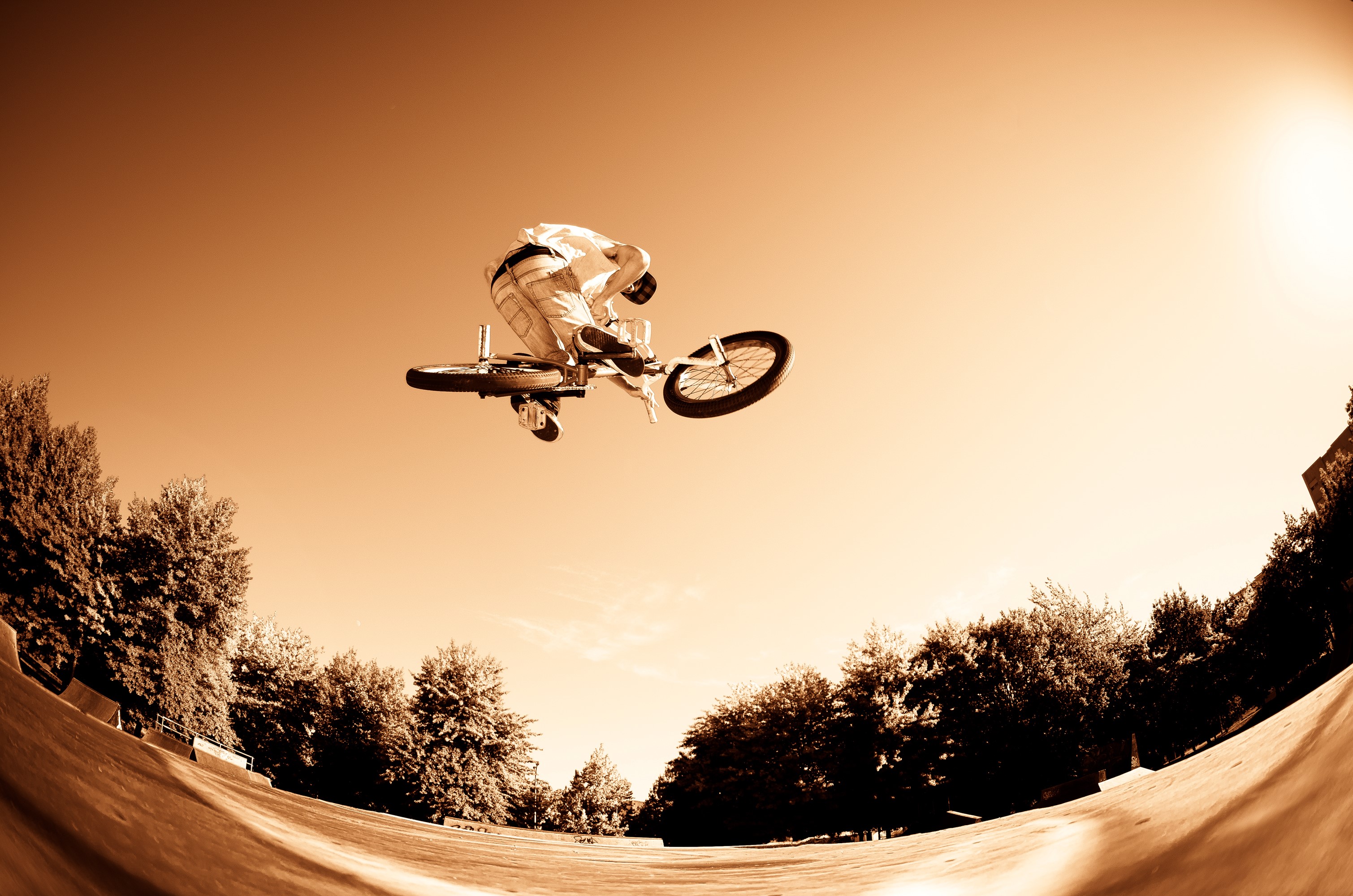 BMX rider performing a trick in the air HD Wallpaper