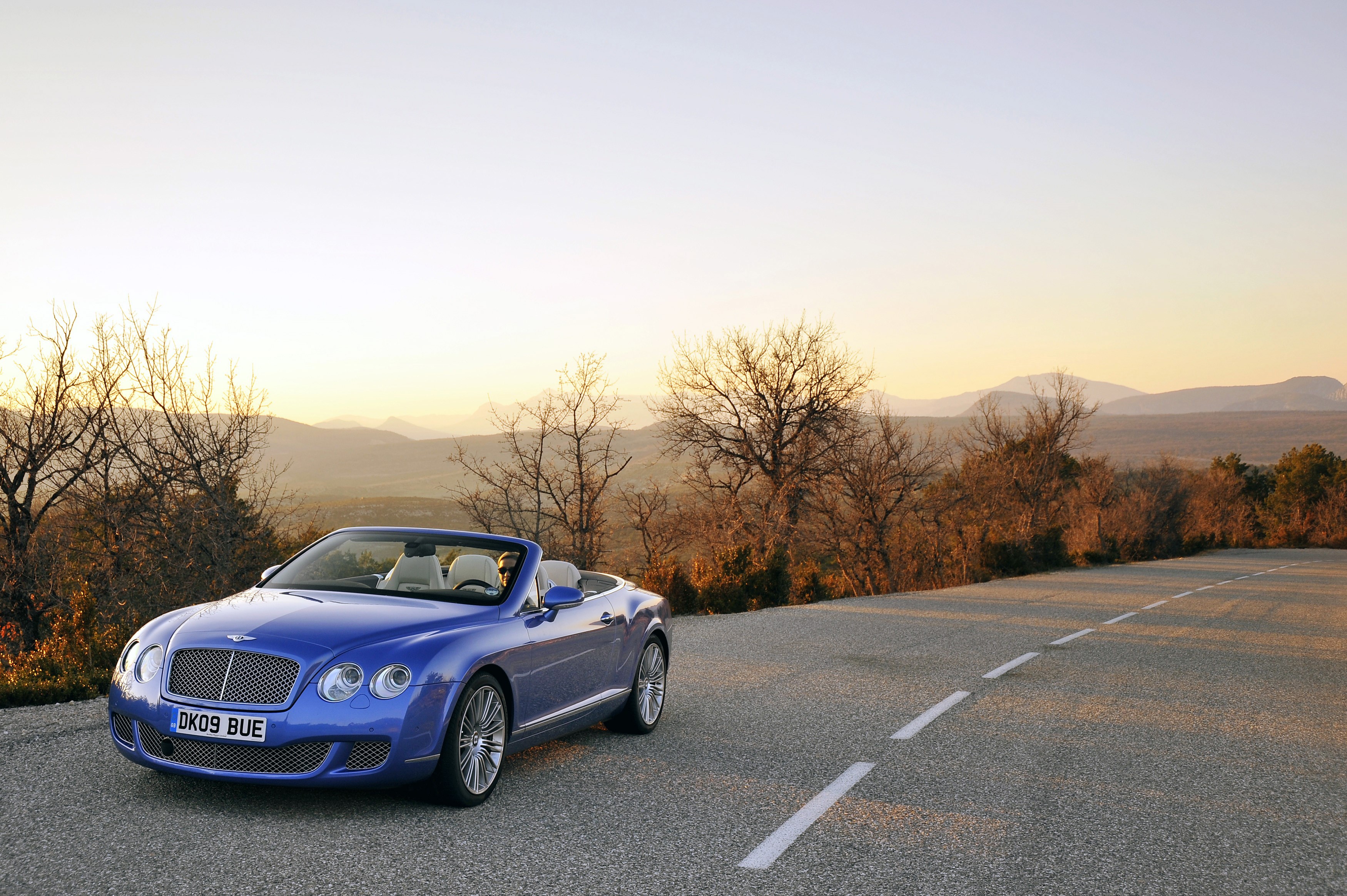 Blue Bentley Continental GTC Speed convertible on a road HD Wallpaper