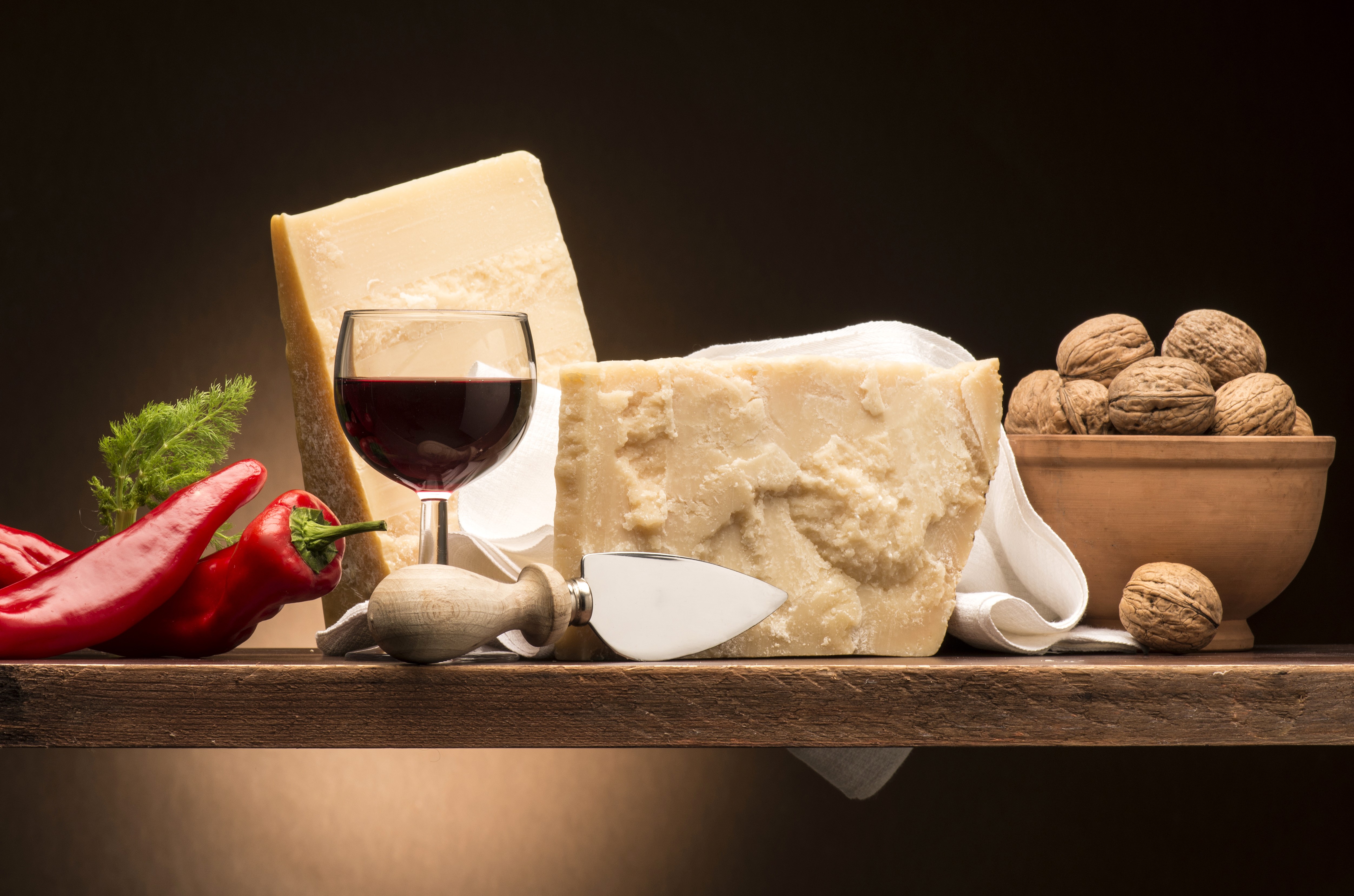 Still-life of cheese, red peppers, wine, and walnuts HD Wallpaper