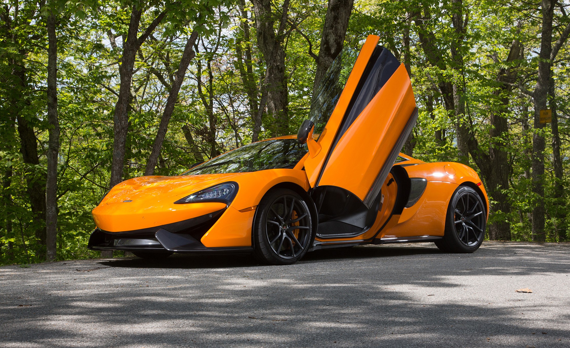 Orange McLaren 570S with doors open HD Wallpaper