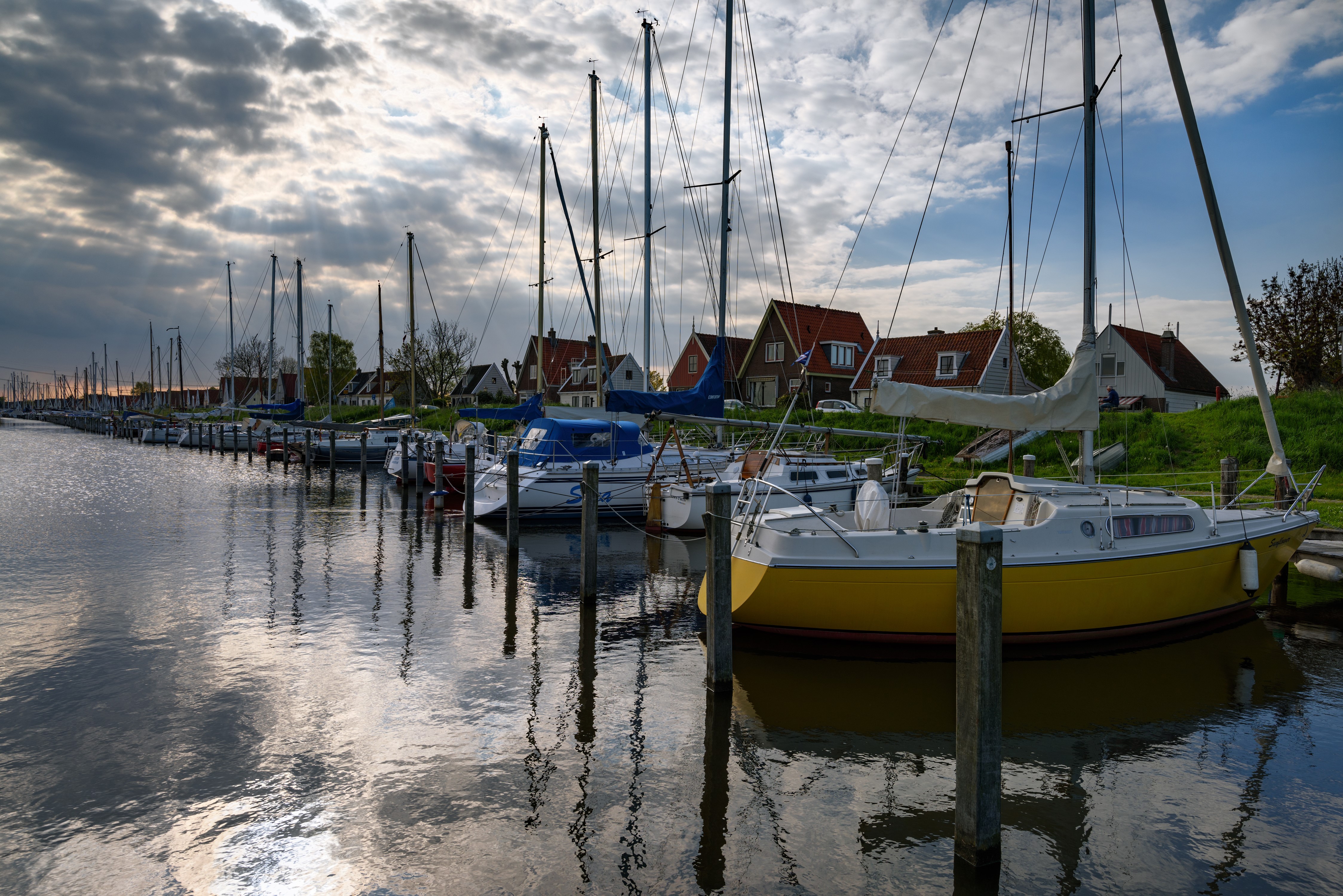 Sailboats docked in a marina in Durgerdam, Netherlands HD Wallpaper