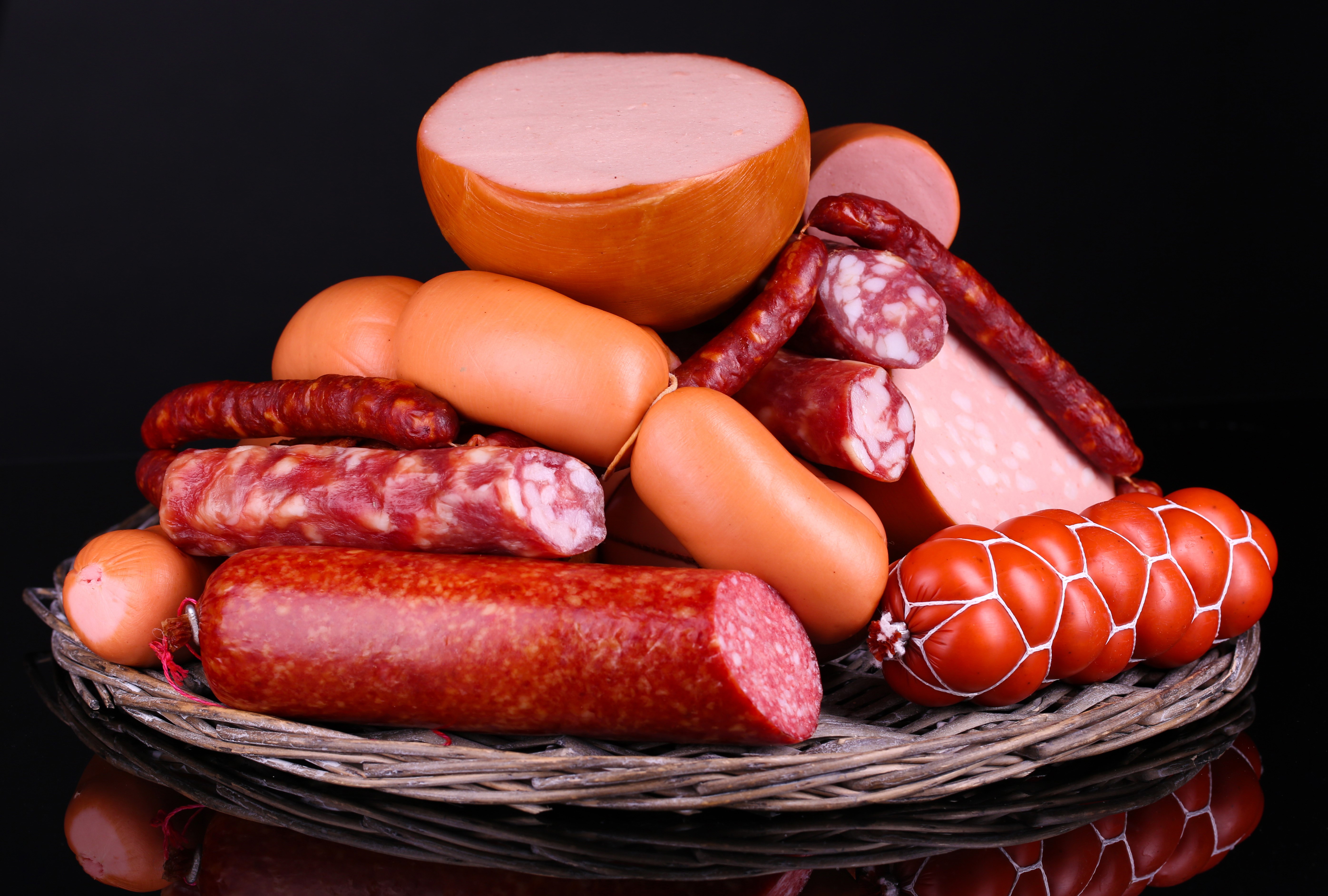 Assortment of sausages on a black background HD Wallpaper