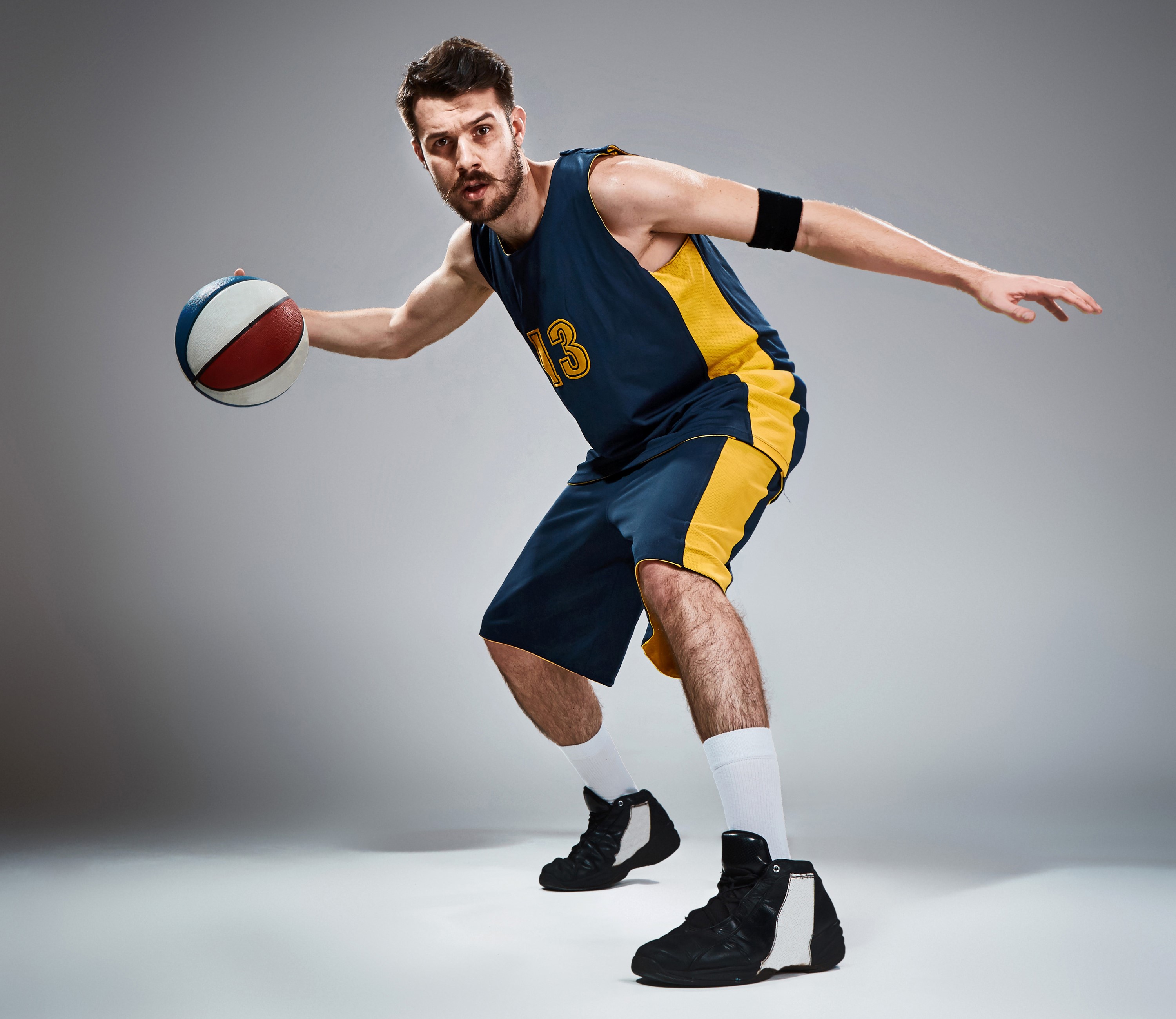 Man in basketball uniform dribbling a ball HD Wallpaper