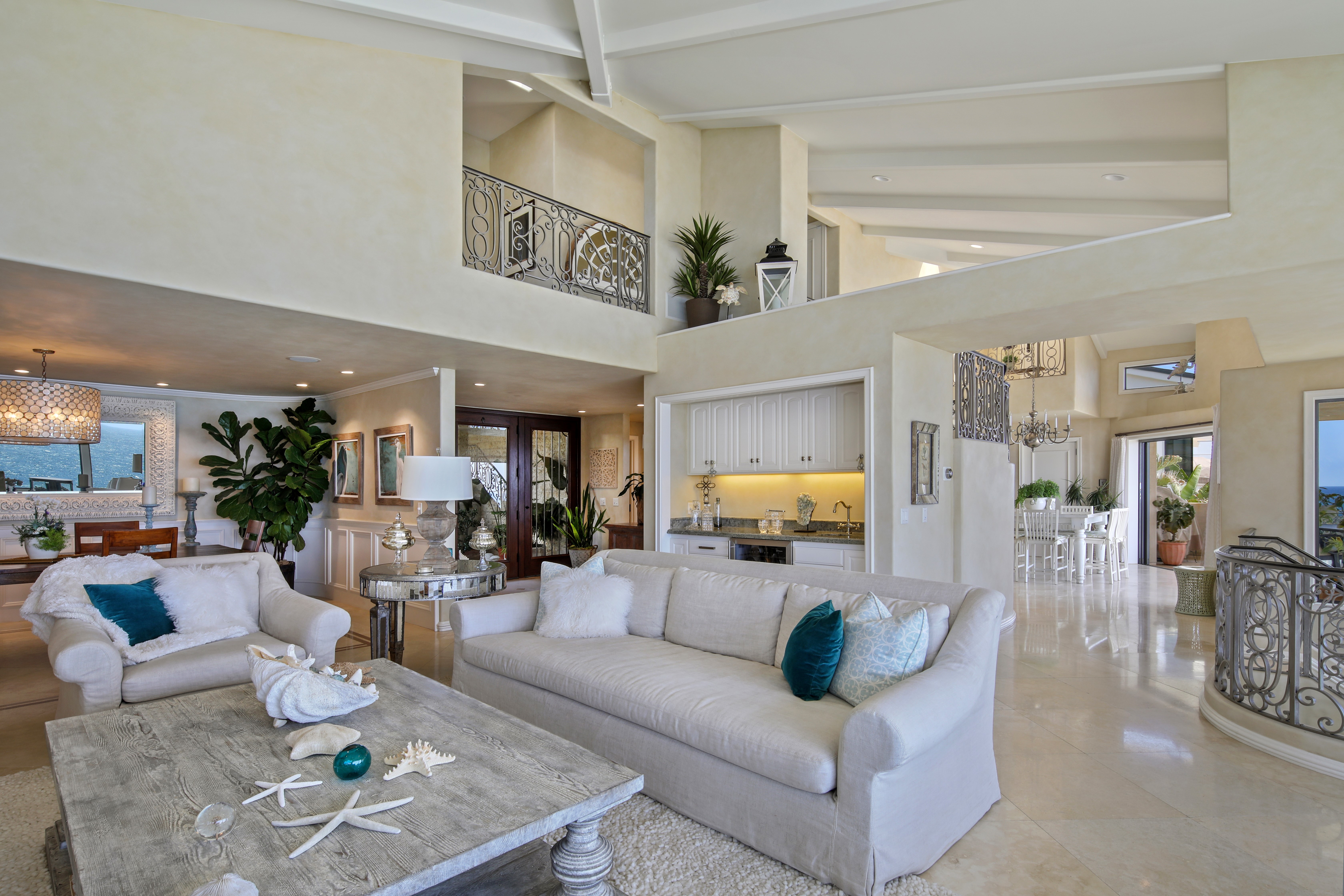 Living room with sofas, coffee table, and bar area HD Wallpaper