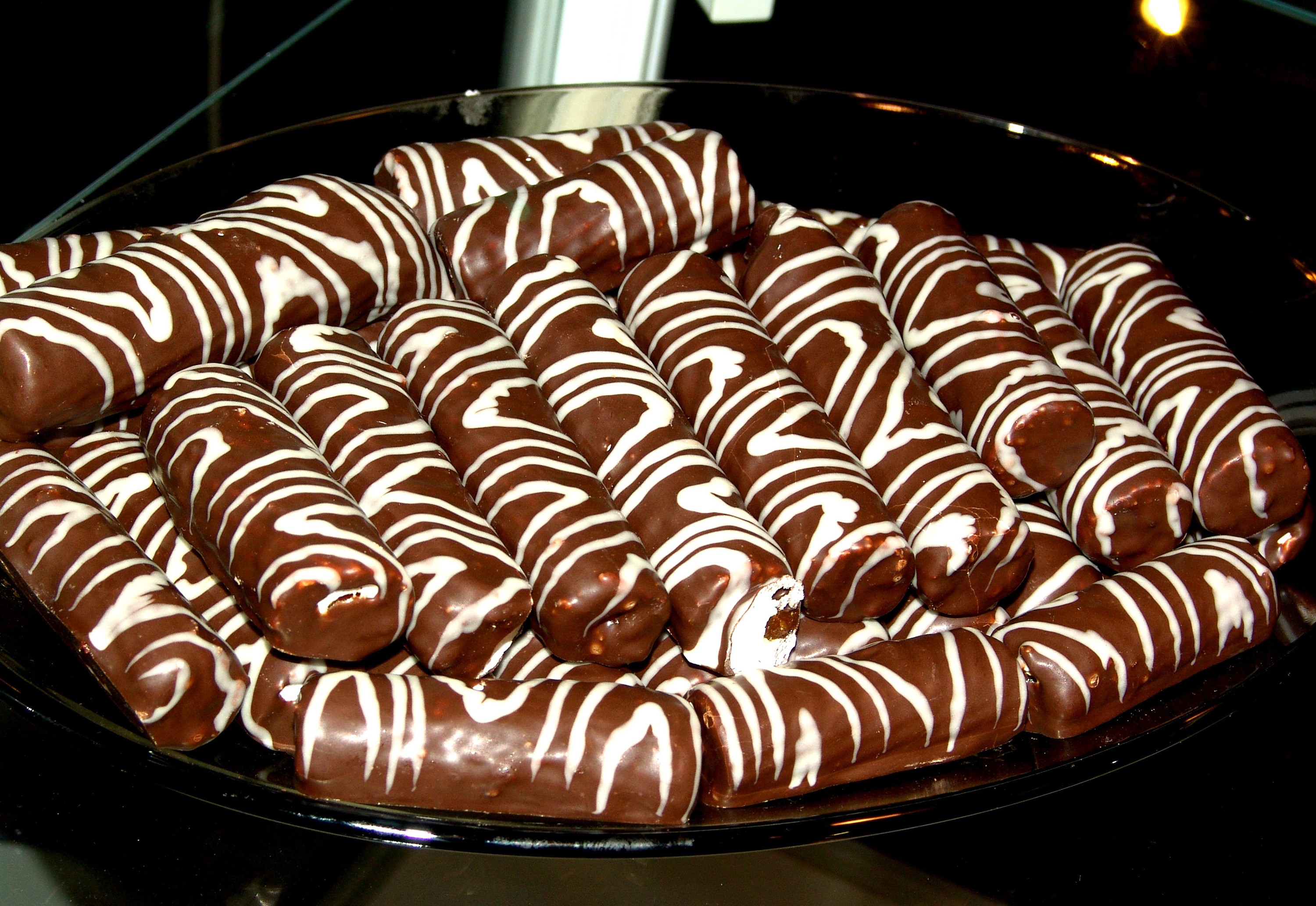 Chocolate pastries with white icing stripes HD Wallpaper
