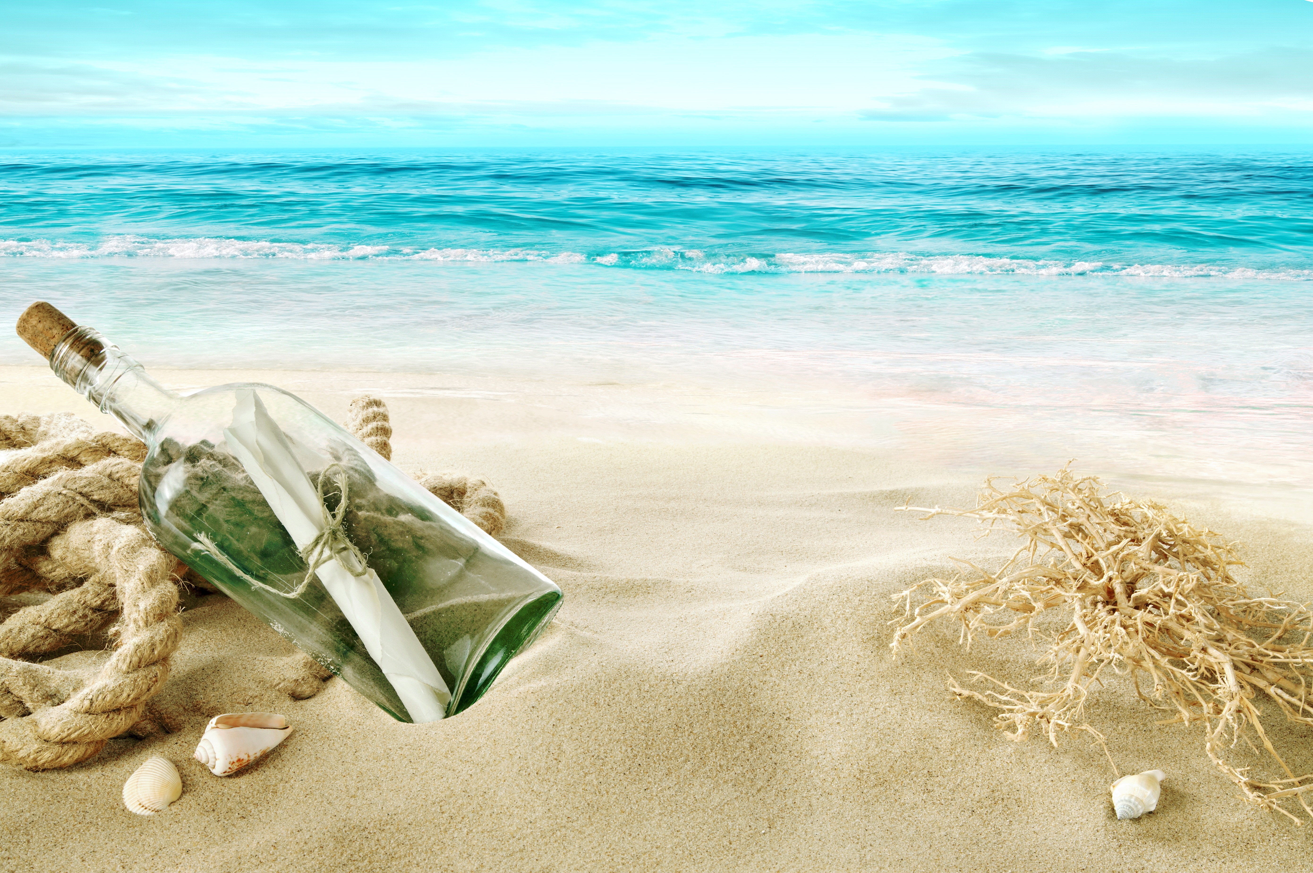 Message in a bottle on a sandy beach with the sea HD Wallpaper
