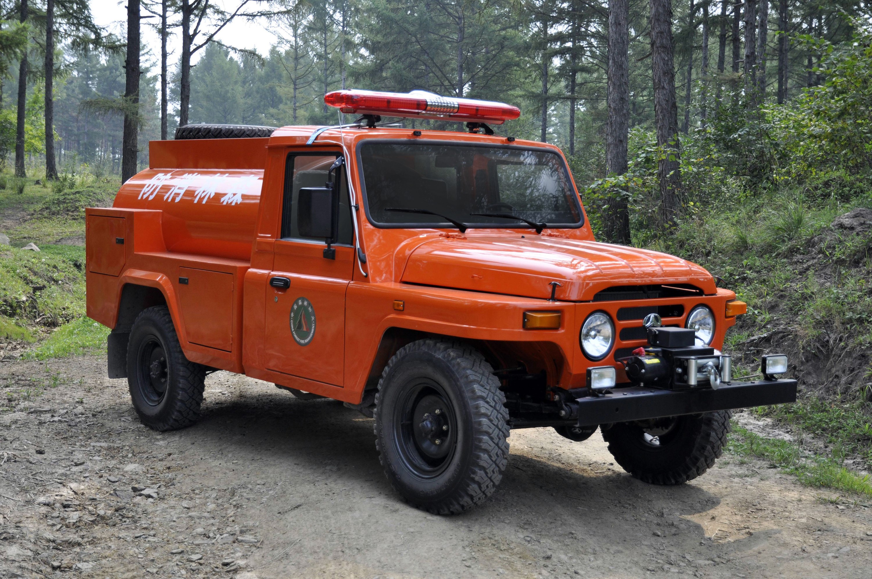 Orange Beijing BJ5042GGS12 fire truck in forest HD Wallpaper