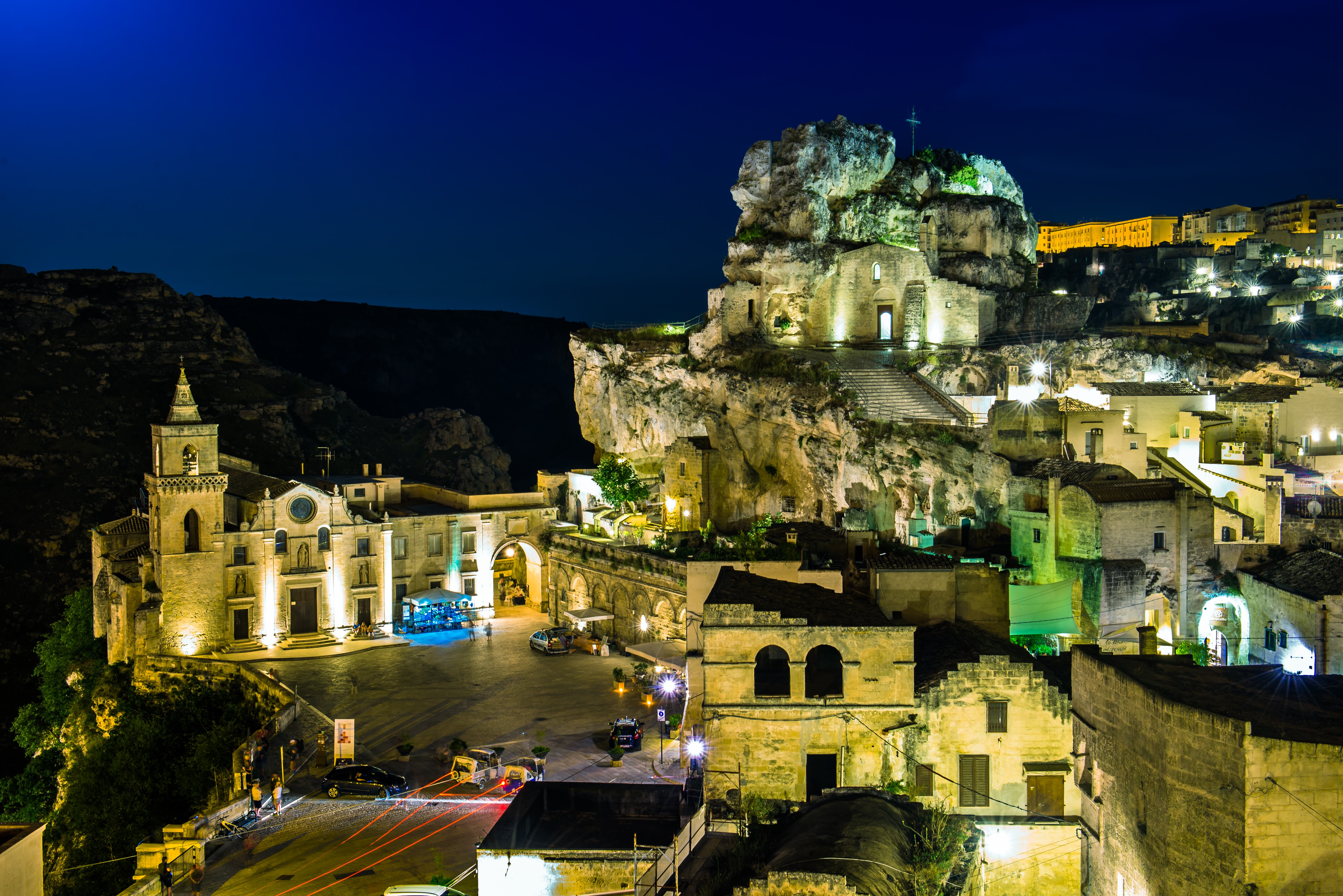 Matera, Italy at night with illuminated buildings and rock formations HD Wallpaper