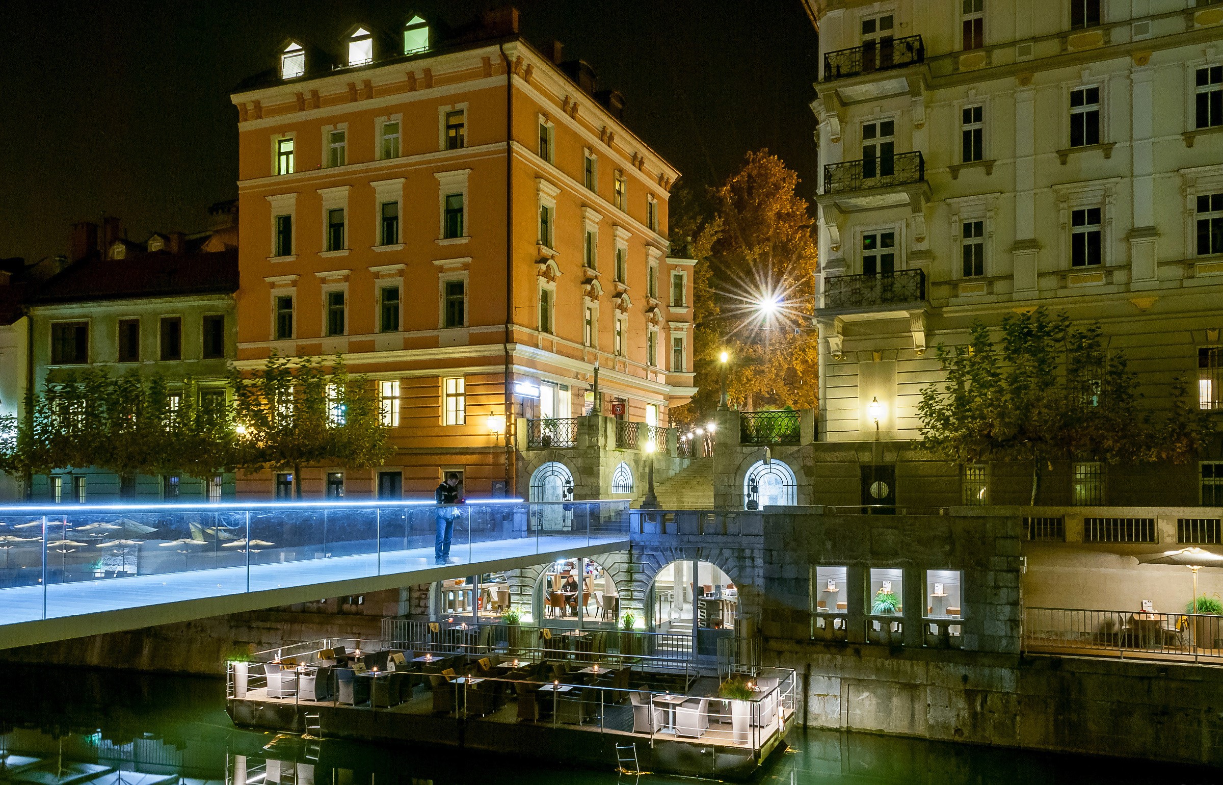 Night view of Ljubljana with a modern bridge and buildings HD Wallpaper