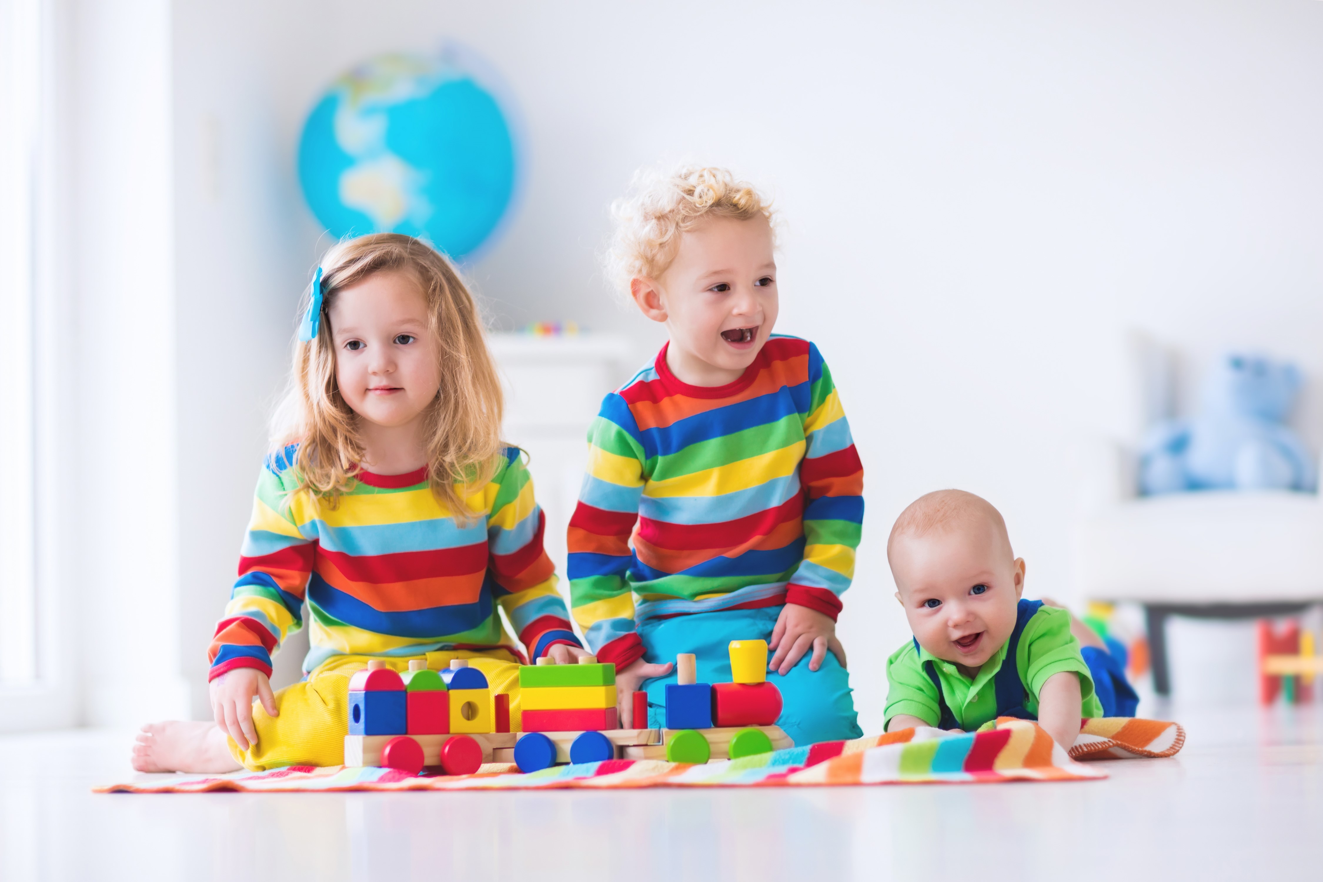 Three Children Playing with a Toy Train HD Wallpaper