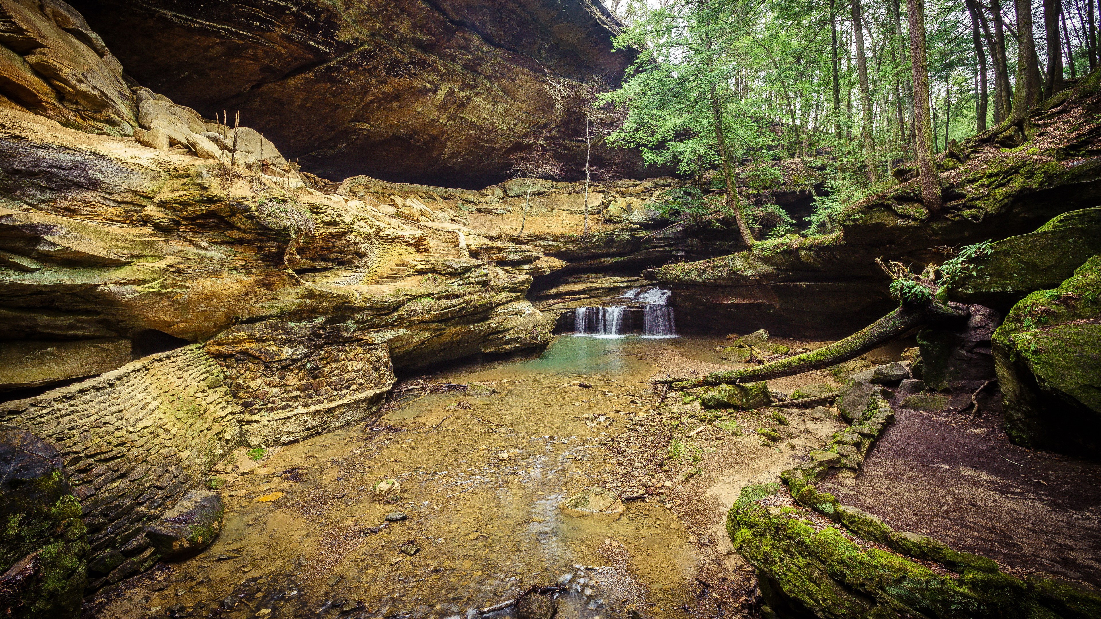 Waterfall cascading into a pool in a rocky gorge HD Wallpaper